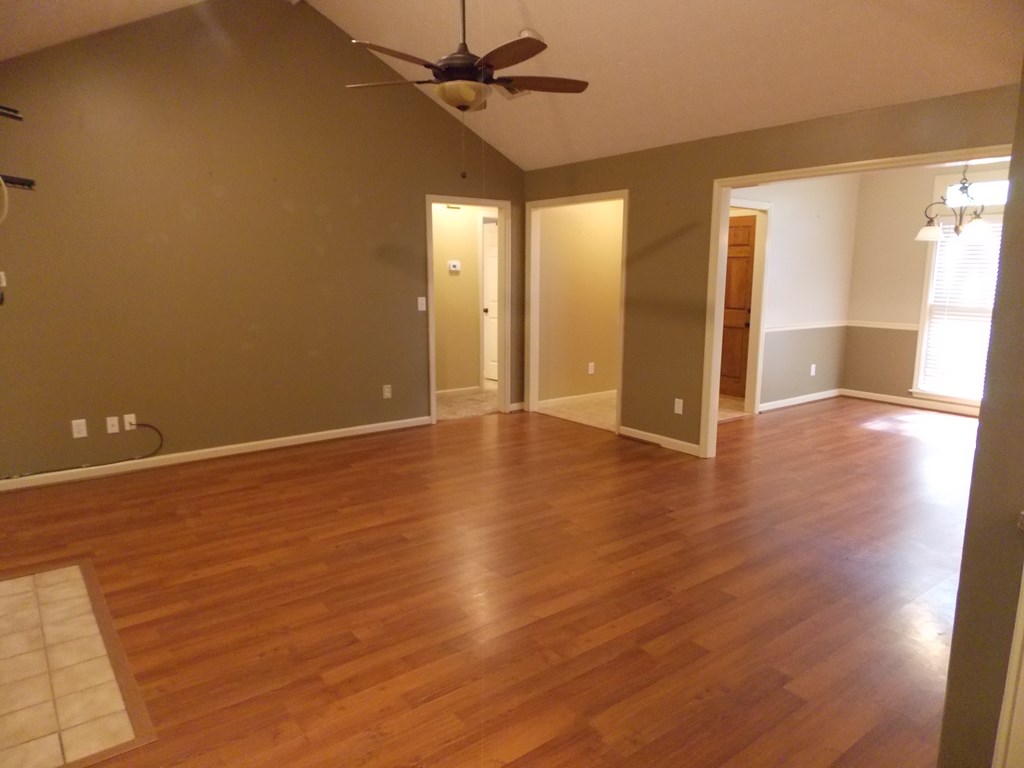 562 Evergreen Drive Fortson, GA 31808 - Photo 3 of 9 an empty room with wooden floor and windows