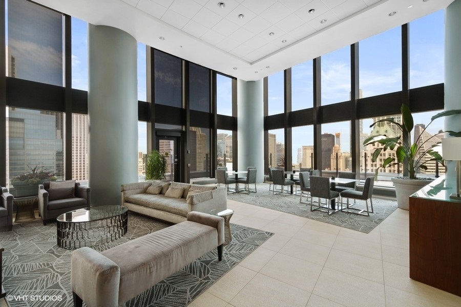 60 East Monroe Street, Unit 2005 Chicago, IL 60603 - Photo 12 of 13 a living room with furniture and large windows