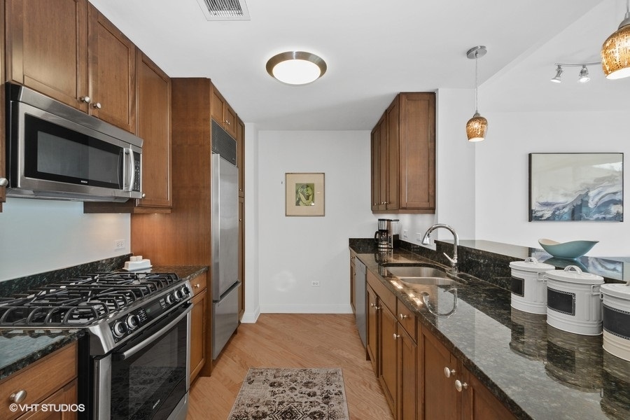 60 East Monroe Street, Unit 2005 Chicago, IL 60603 - Photo 6 of 13 a kitchen that has a sink and a stove