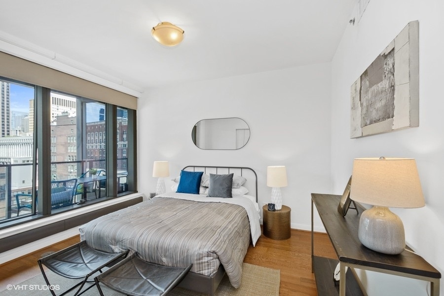 60 East Monroe Street, Unit 2005 Chicago, IL 60603 - Photo 7 of 13 a bedroom with a bed and window