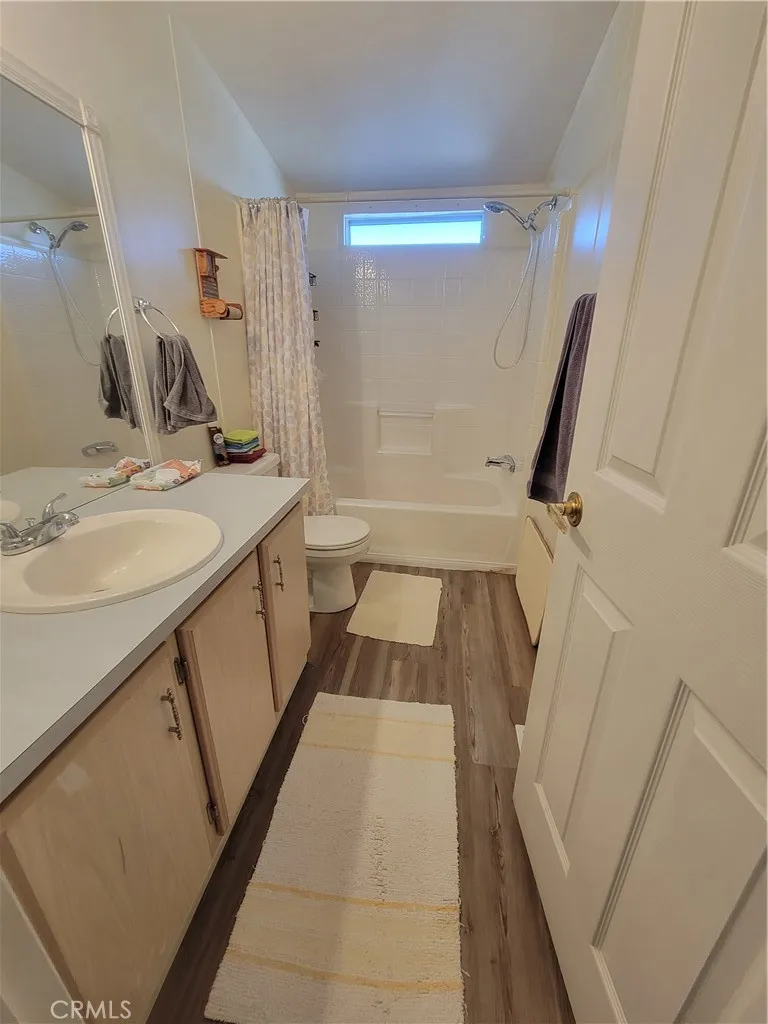 14000 El Evado Road, Unit 43 Victorville, CA 92392 - Photo 13 of 16 a bathroom with a sink a toilet a mirror and shower