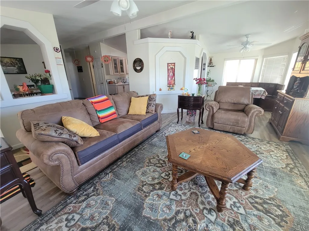 14000 El Evado Road, Unit 43 Victorville, CA 92392 - Photo 7 of 16 a living room with furniture and wooden floor