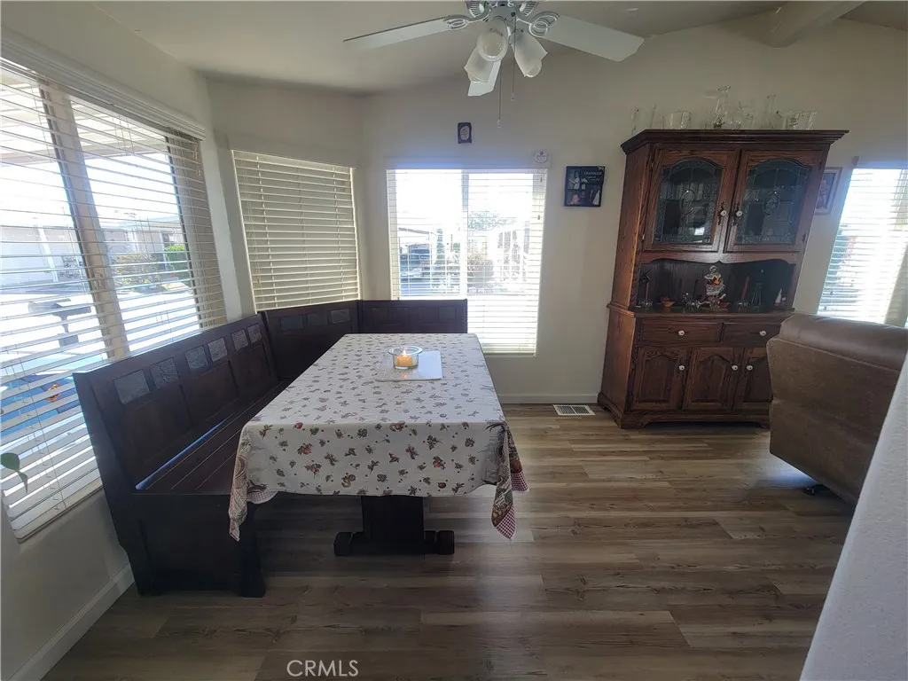 14000 El Evado Road, Unit 43 Victorville, CA 92392 - Photo 9 of 16 a living room with furniture and a wooden floor