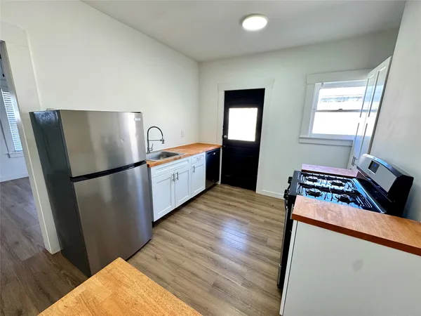 a kitchen with wooden floors and a stove