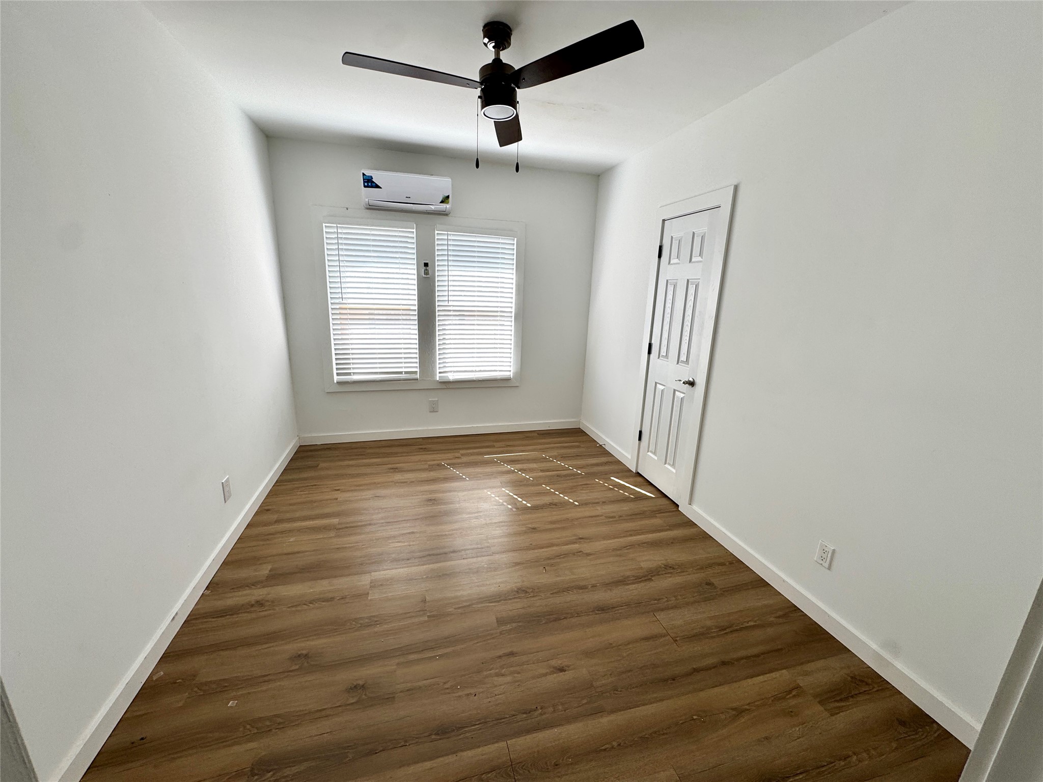 7-9 Hunt Street Houston, TX 77003 - Photo 7 of 23 an empty room with wooden floor and windows