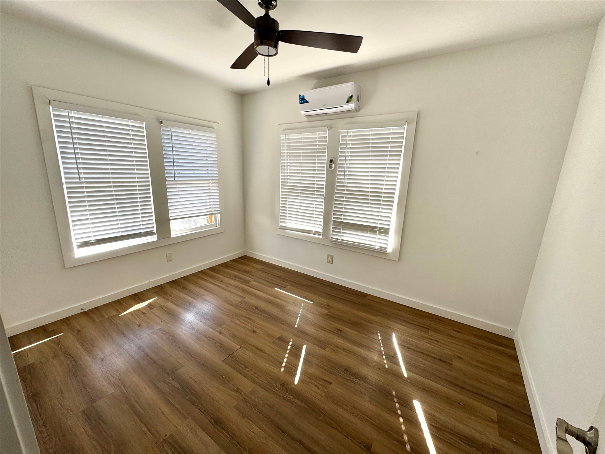7-9 Hunt Street Houston, TX 77003 - Photo 9 of 23 a view of empty room with wooden floor and fan