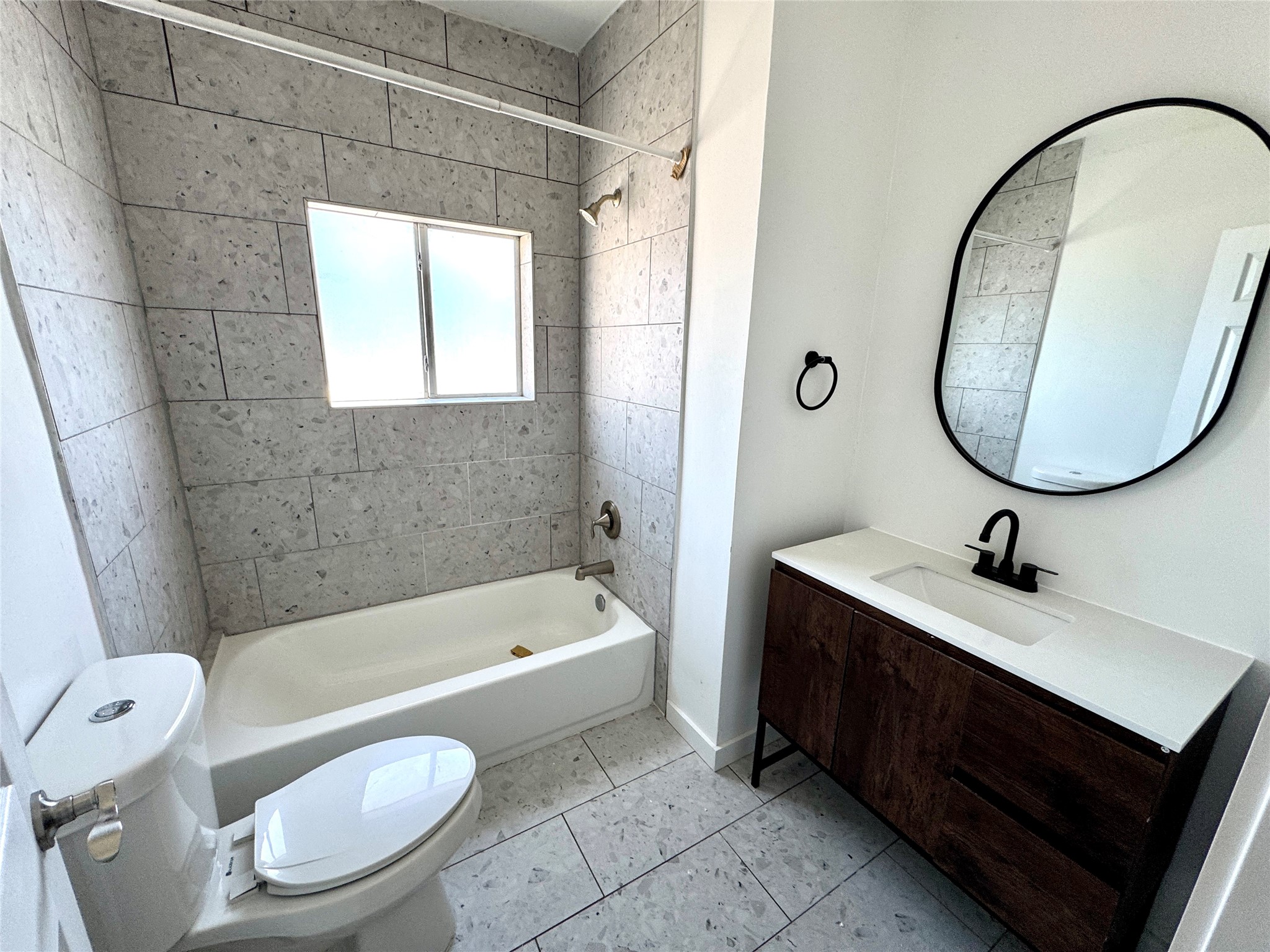 7-9 Hunt Street Houston, TX 77003 - Photo 10 of 23 a bathroom with a sink a toilet a mirror and bathtub