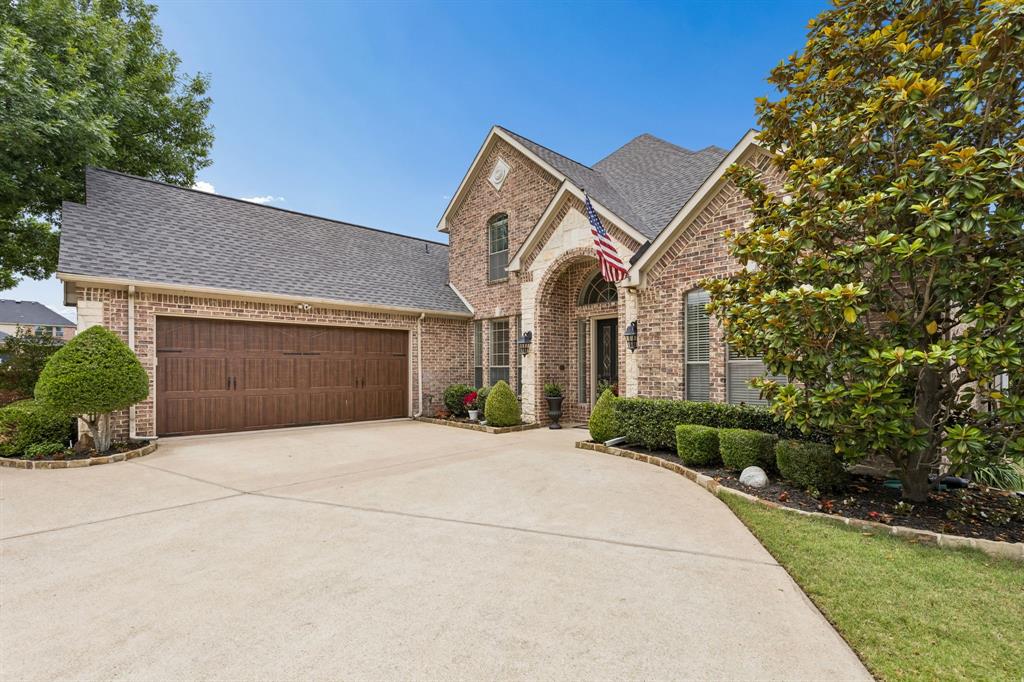 8517 Navigation Drive Rowlett, TX 75088 - Photo 5 of 39 a front view of a house with a yard and garage