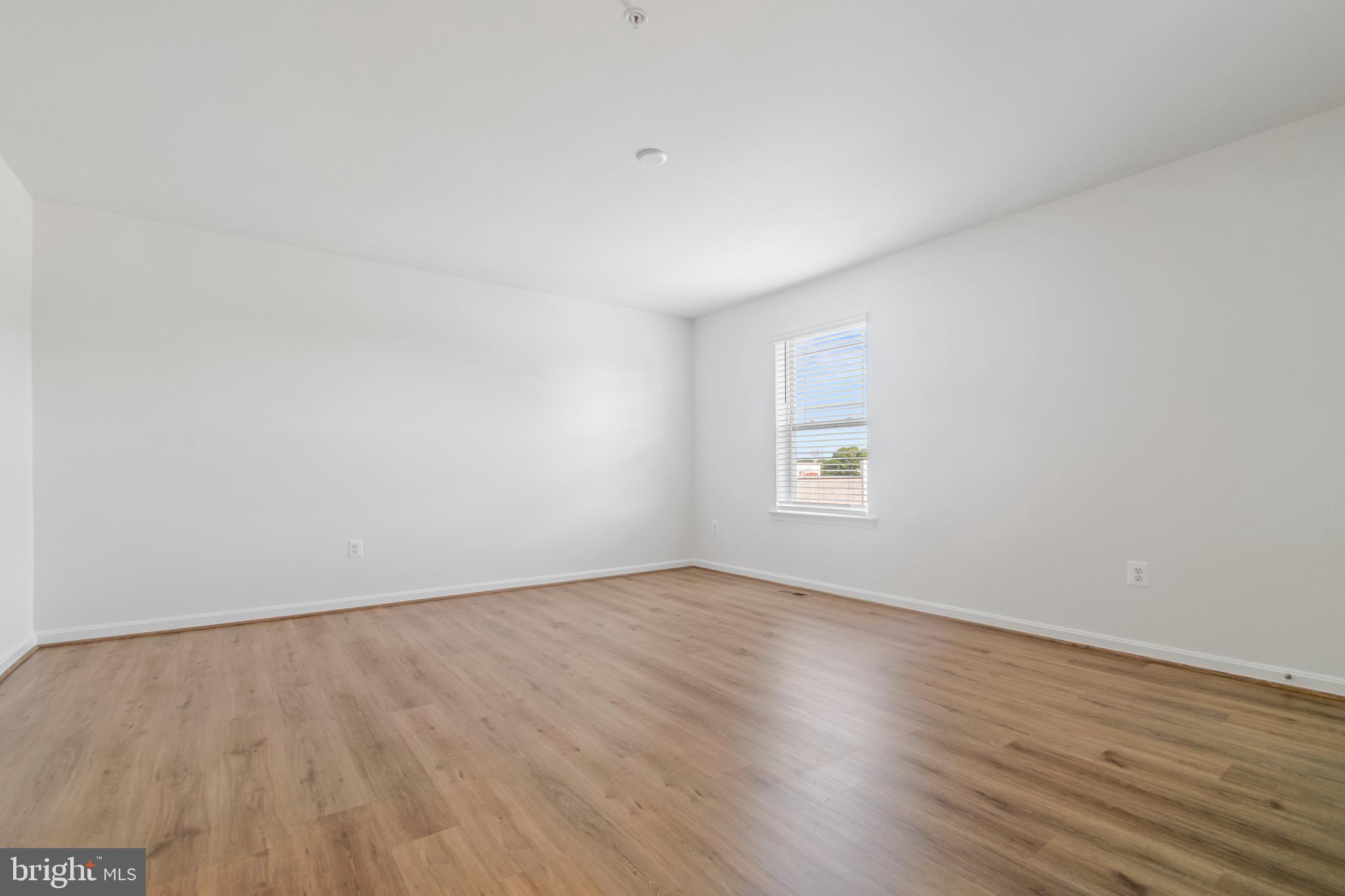 7811 Wolf Run Lane Severn, MD 21144 - Photo 15 of 32 an empty room with wooden floor and windows