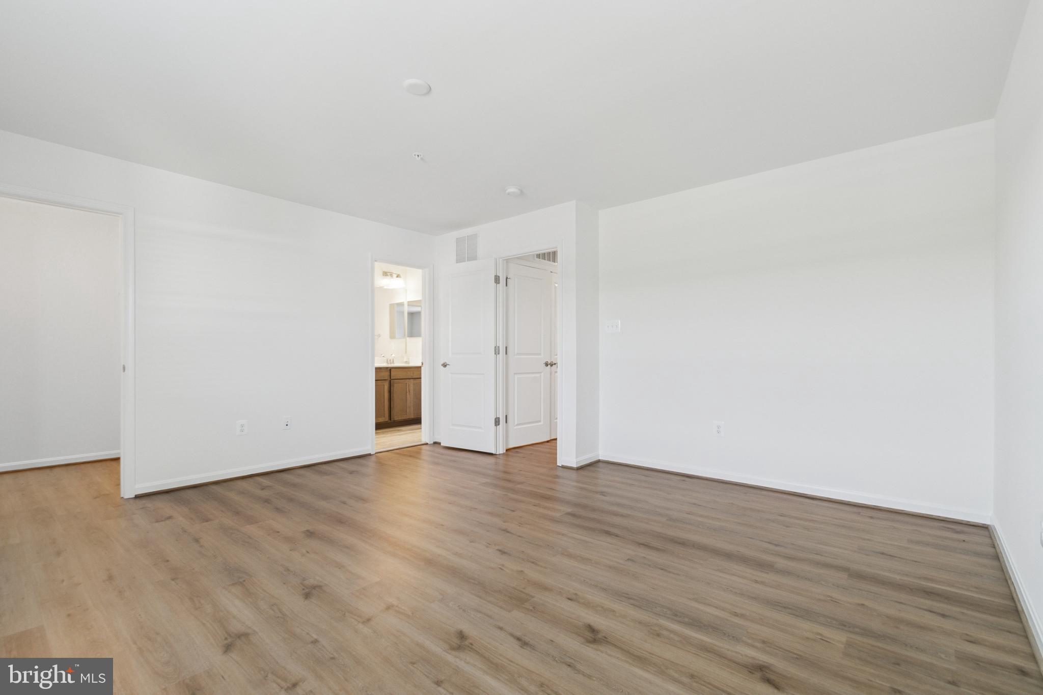 7811 Wolf Run Lane Severn, MD 21144 - Photo 16 of 32 a view of an empty room with wooden floor and entryway