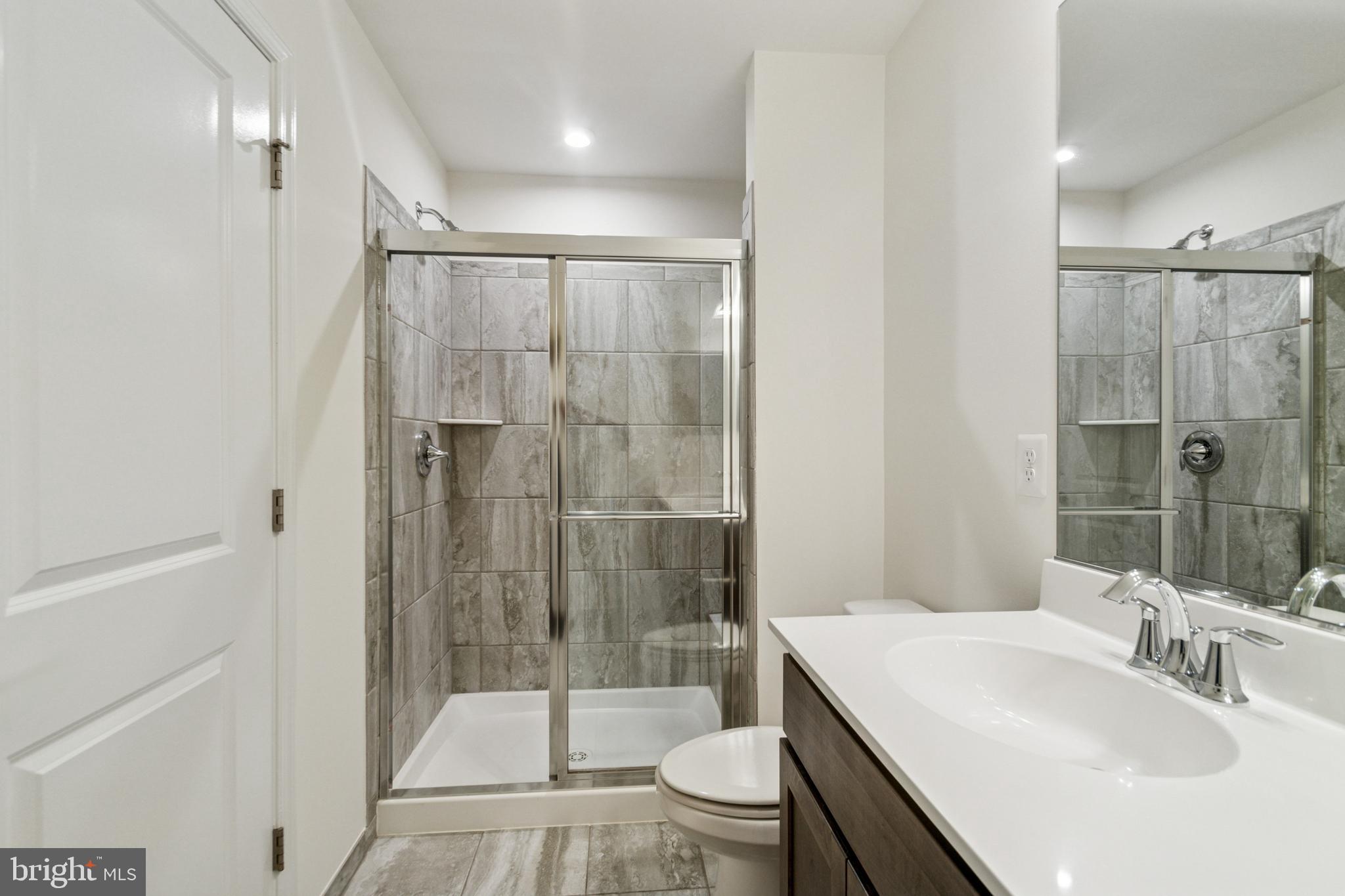 7811 Wolf Run Lane Severn, MD 21144 - Photo 17 of 32 a bathroom with a sink toilet and shower