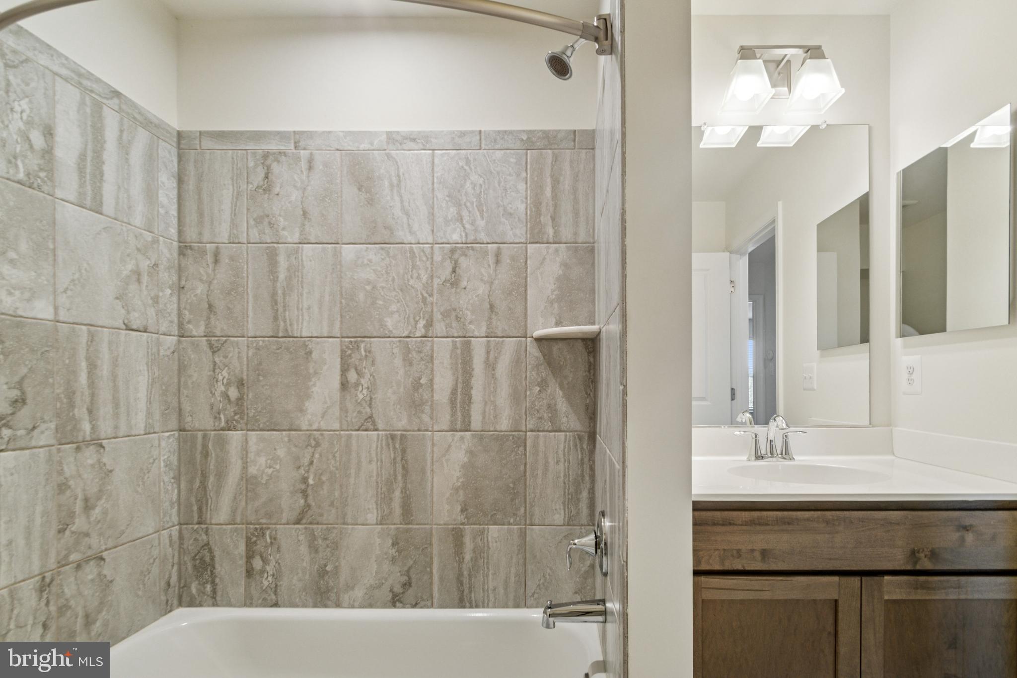 7811 Wolf Run Lane Severn, MD 21144 - Photo 22 of 32 a bathroom with a sink and a mirror