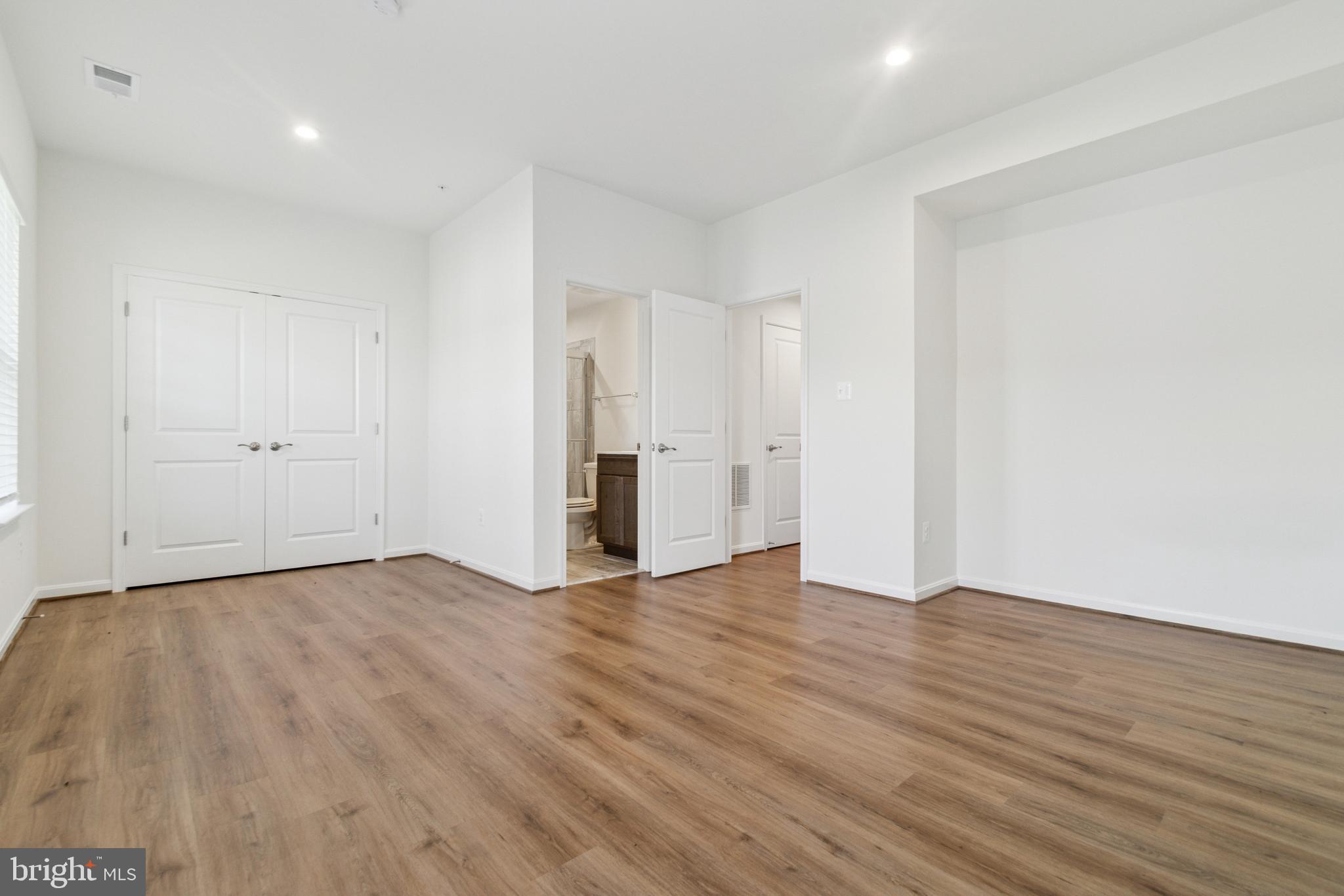 7811 Wolf Run Lane Severn, MD 21144 - Photo 26 of 32 a view of an empty room with wooden floor