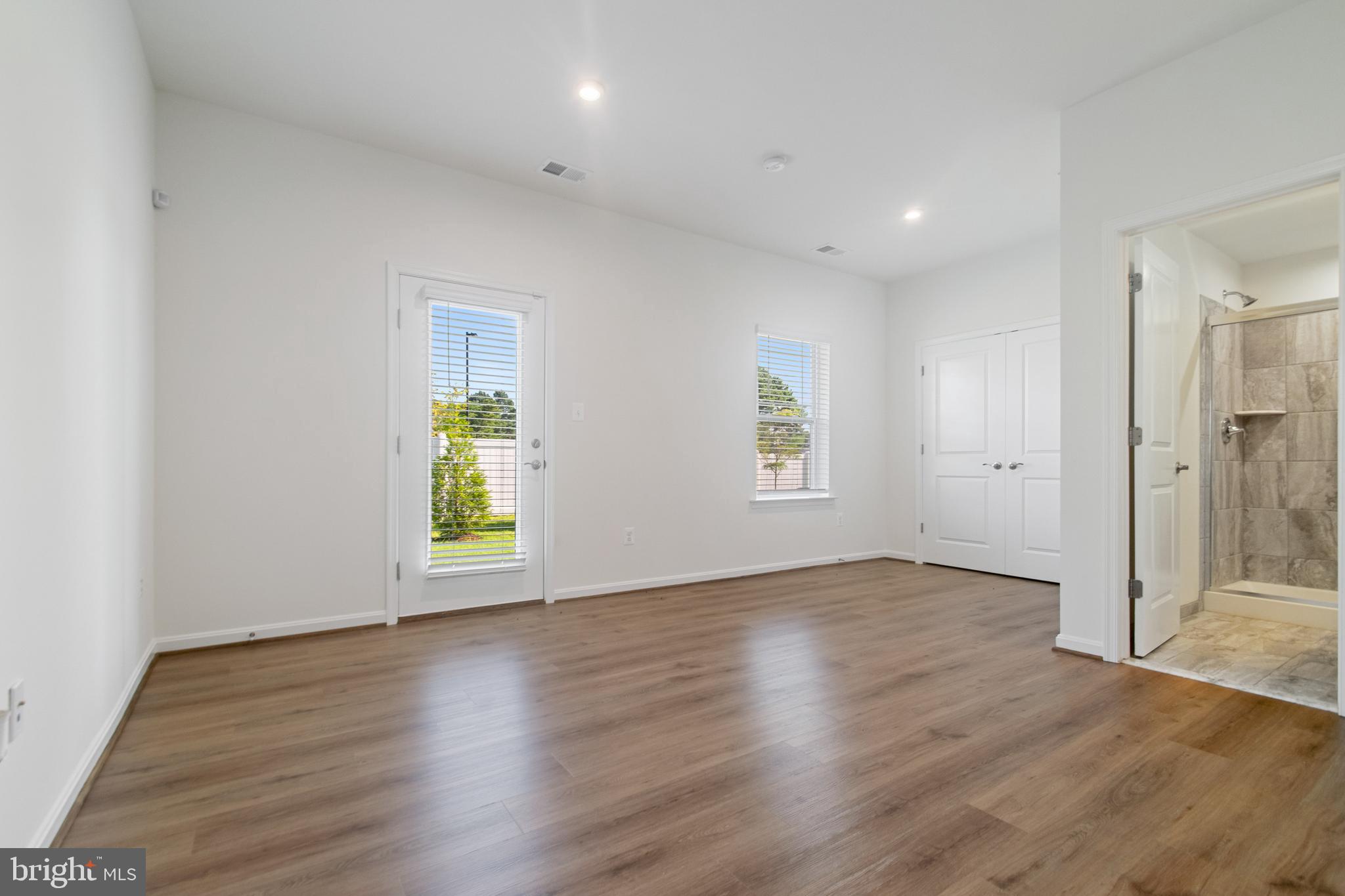 7811 Wolf Run Lane Severn, MD 21144 - Photo 27 of 32 an empty room with wooden floor and windows