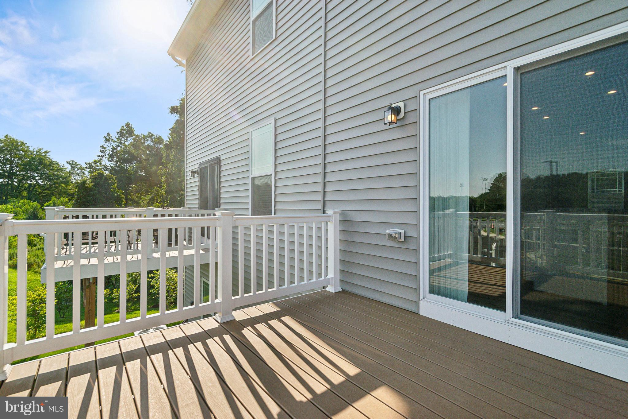 7811 Wolf Run Lane Severn, MD 21144 - Photo 30 of 32 a view of a wooden balcony with wooden floor