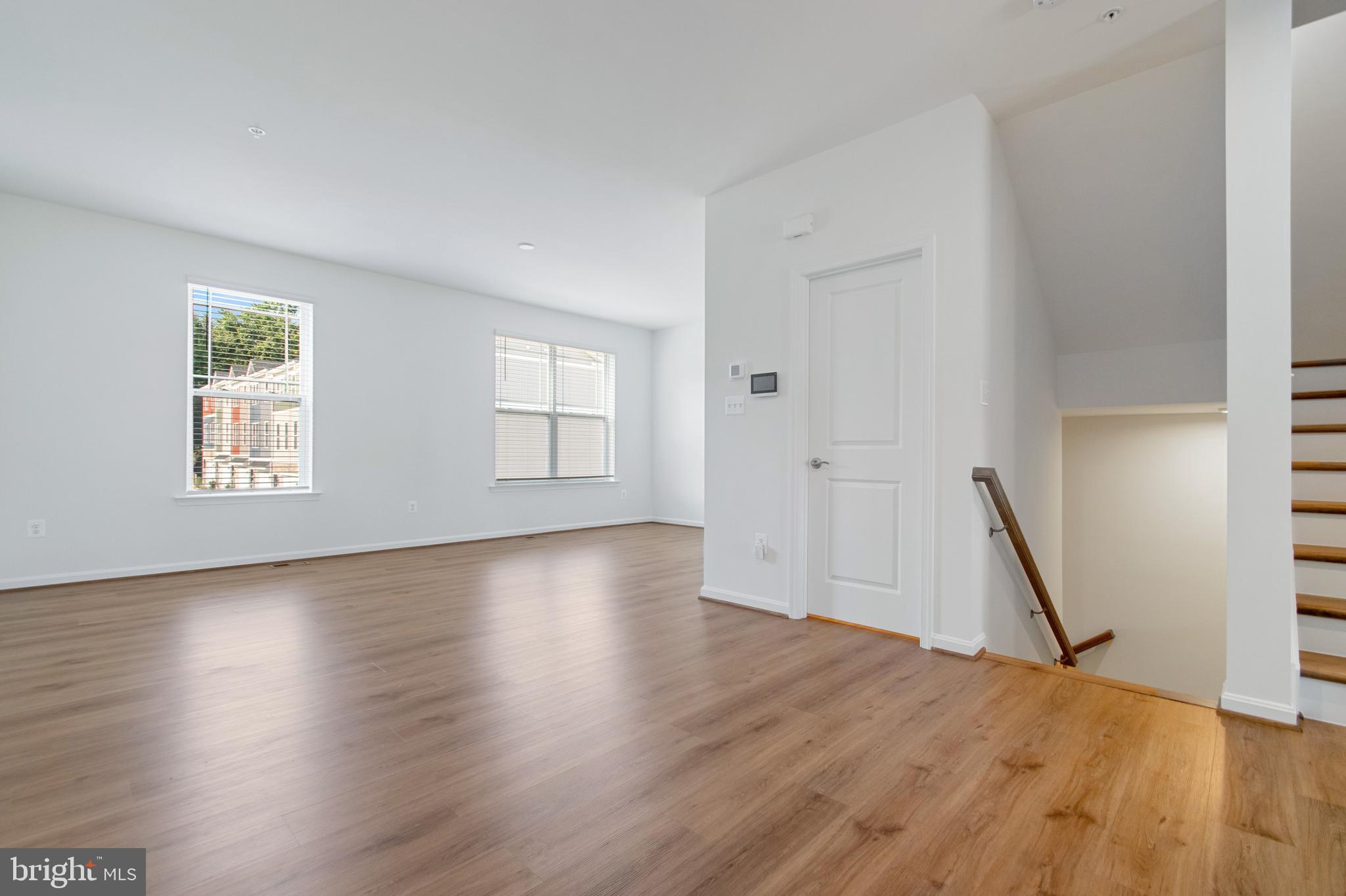7811 Wolf Run Lane Severn, MD 21144 - Photo 3 of 32 an empty room with wooden floor and windows