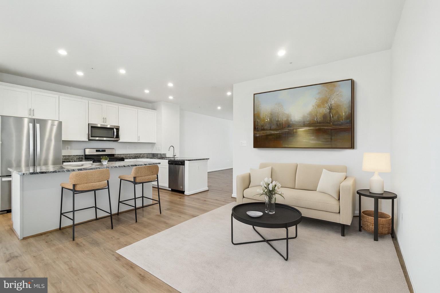7811 Wolf Run Lane Severn, MD 21144 - Photo 4 of 32 a living room with furniture and kitchen view