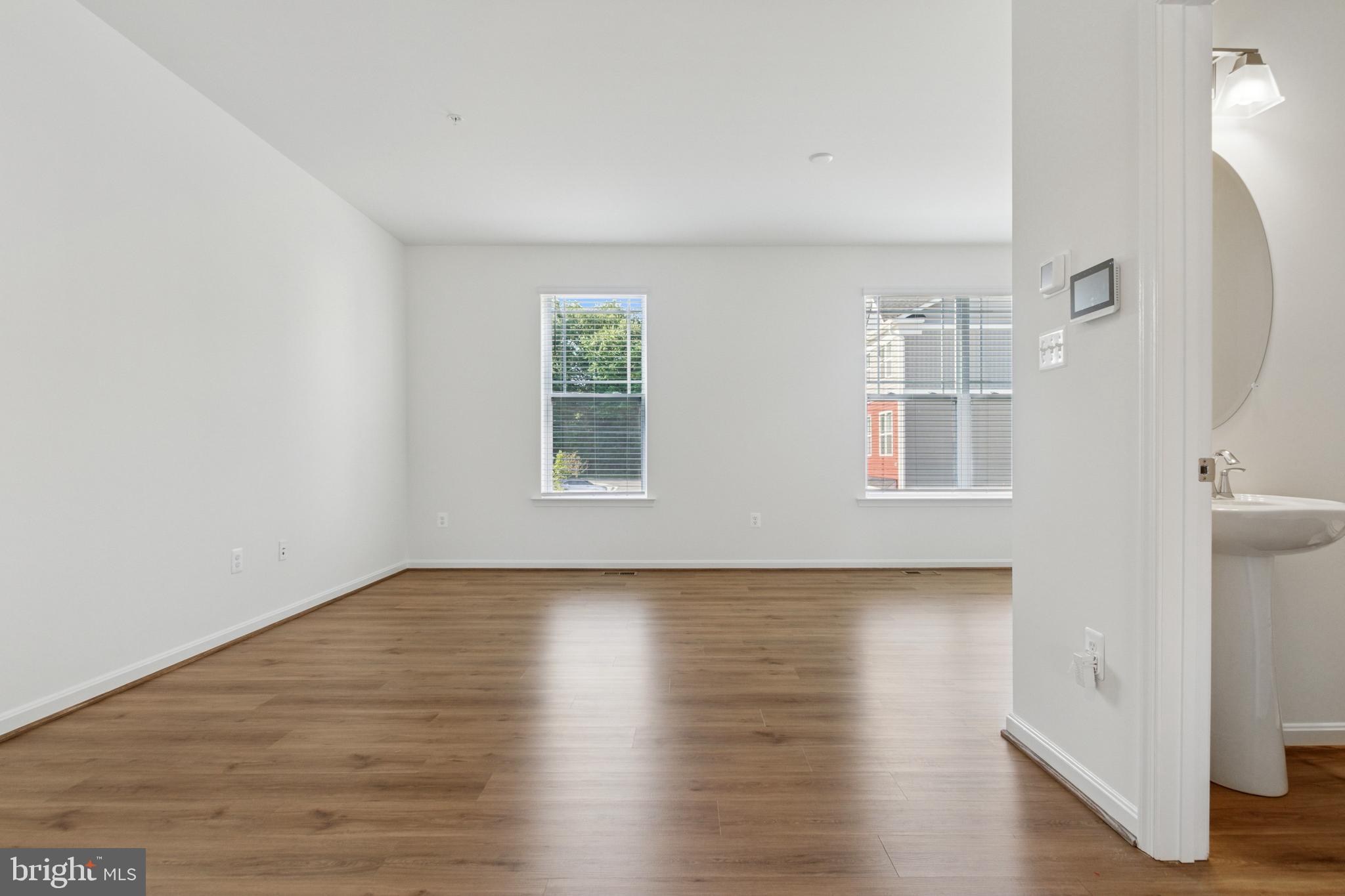 7811 Wolf Run Lane Severn, MD 21144 - Photo 6 of 32 a view of an empty room with wooden floor and a window