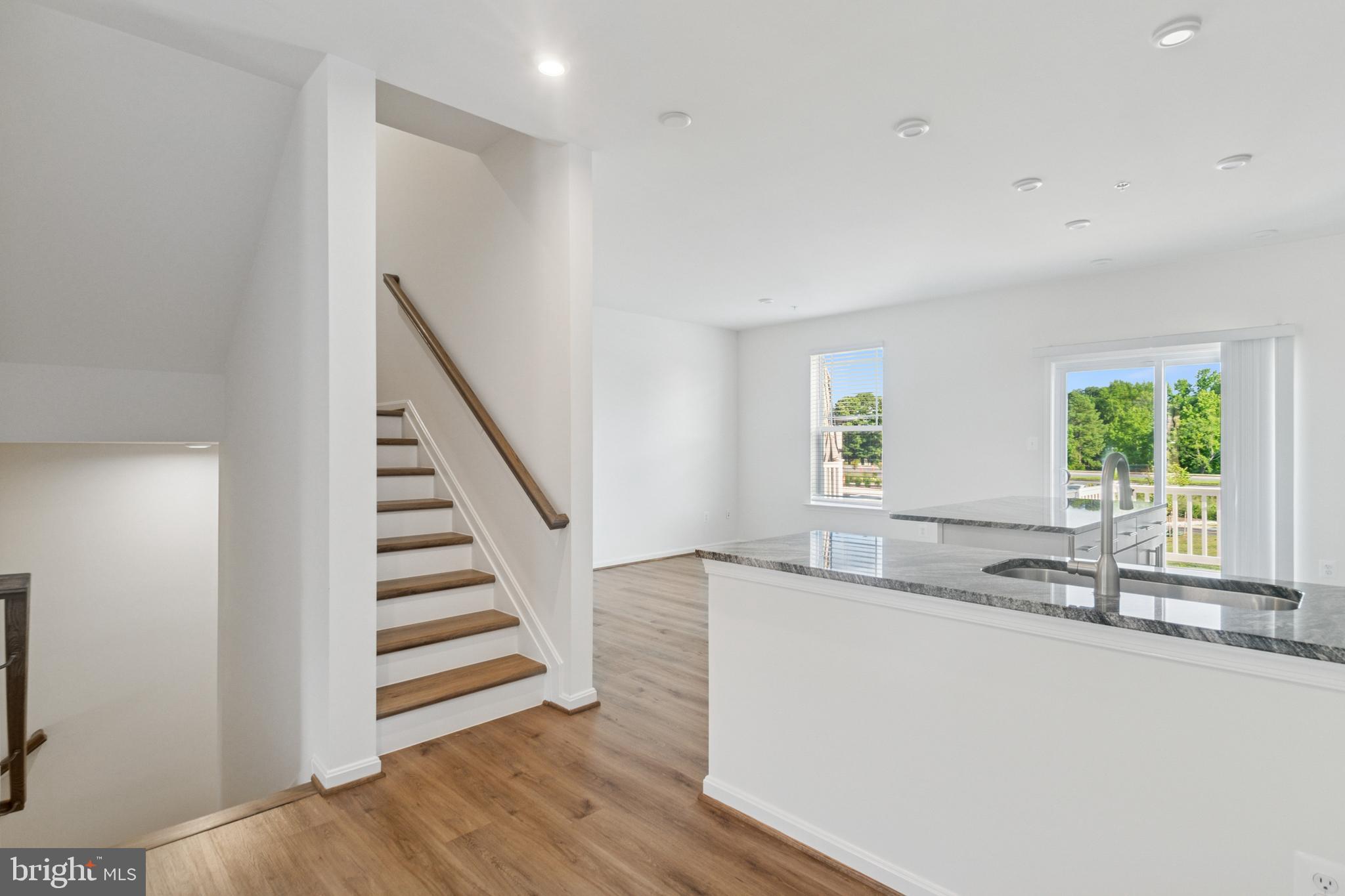 7811 Wolf Run Lane Severn, MD 21144 - Photo 9 of 32 a view of a kitchen with wooden floor and a sink