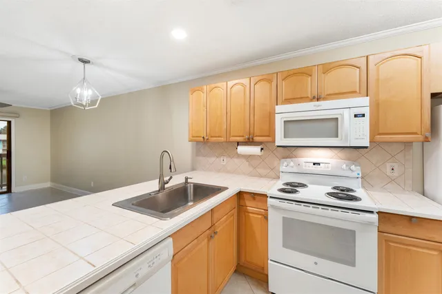 a kitchen with a sink stove and microwave