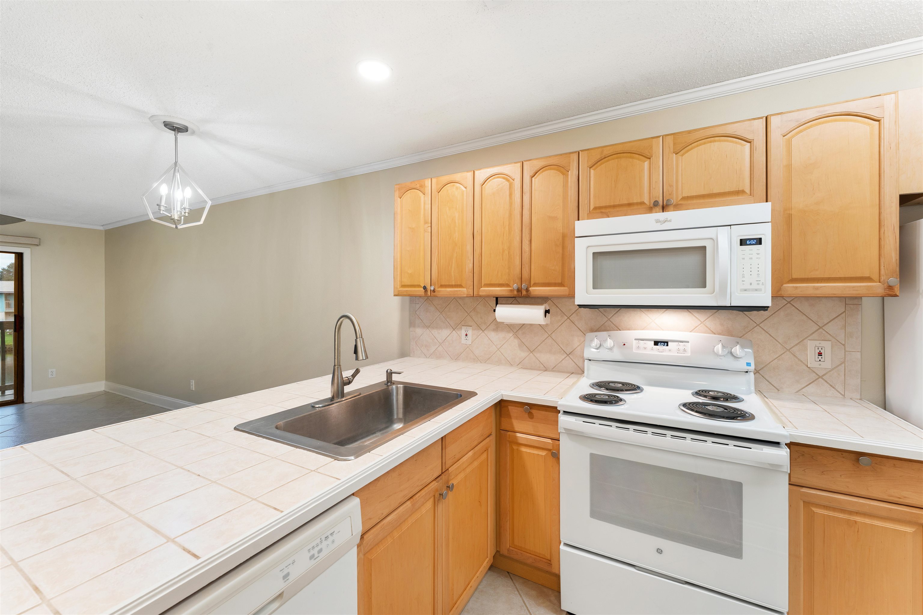 650 West Pope Road, Unit 233 St. Augustine, FL 32080 - Photo 14 of 31 a kitchen with a sink stove and microwave