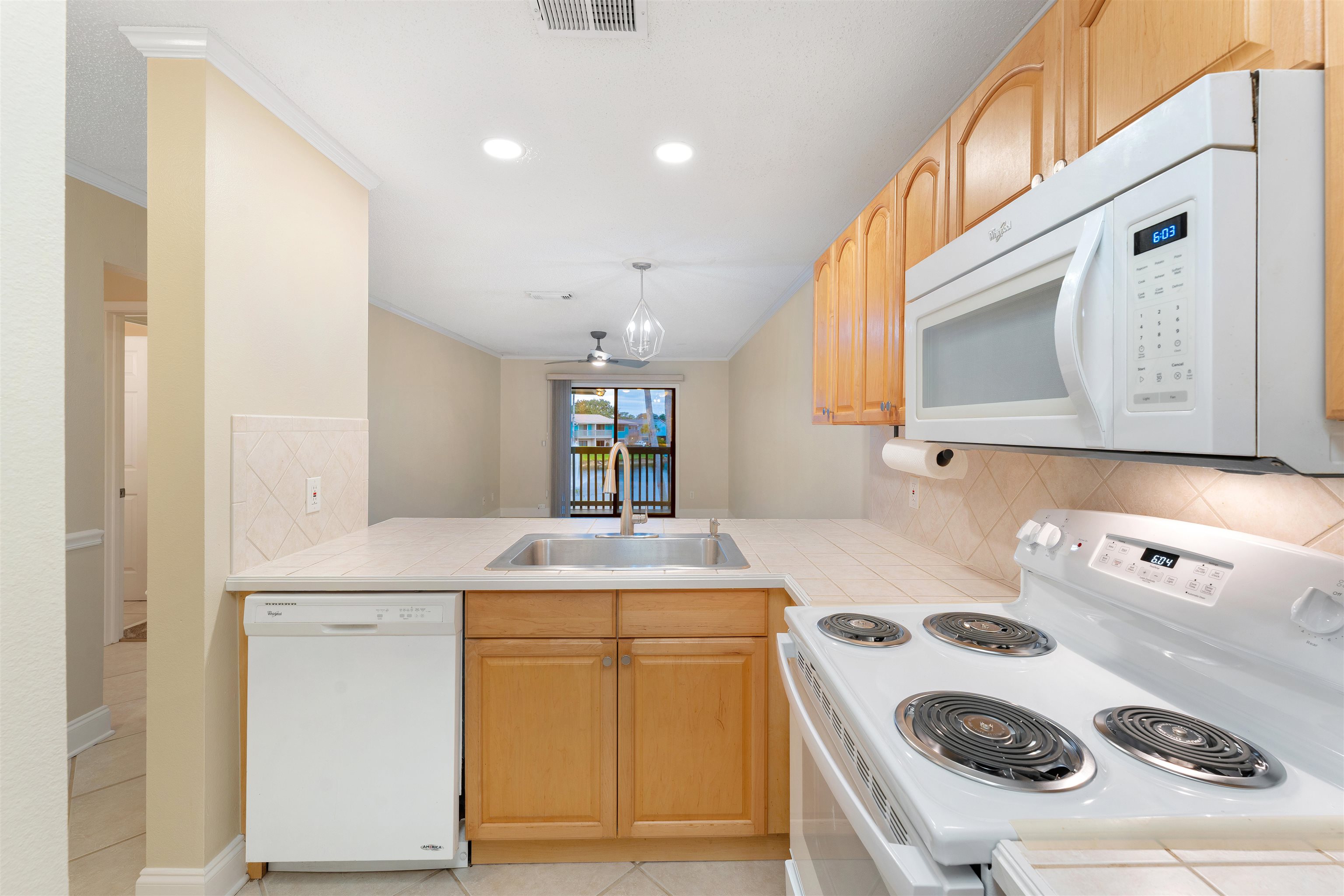 650 West Pope Road, Unit 233 St. Augustine, FL 32080 - Photo 15 of 31 a kitchen with a sink a stove and cabinets