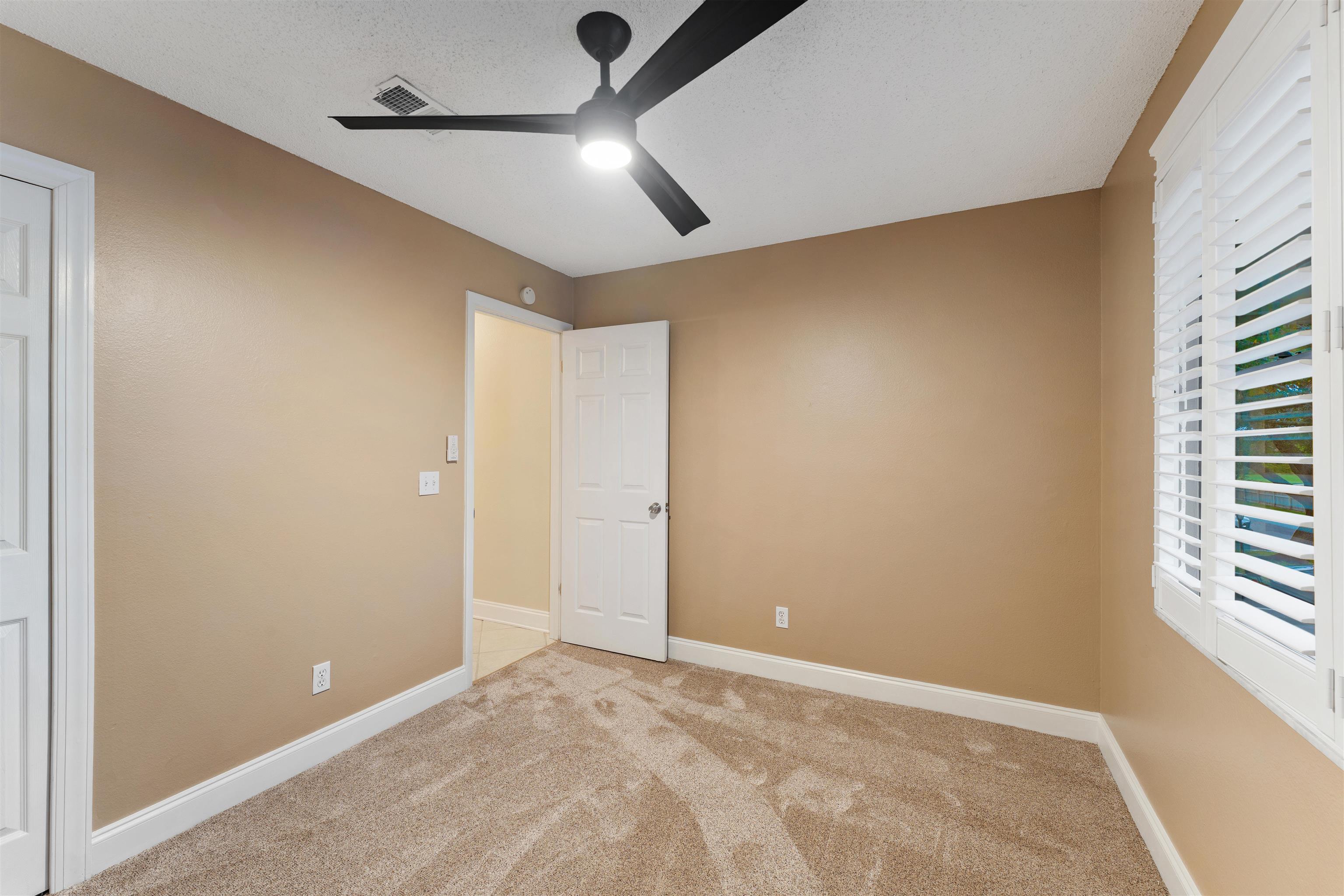 650 West Pope Road, Unit 233 St. Augustine, FL 32080 - Photo 22 of 31 an empty room with windows and fan