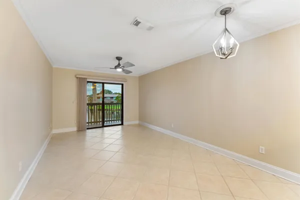 a view of an empty room with glass door