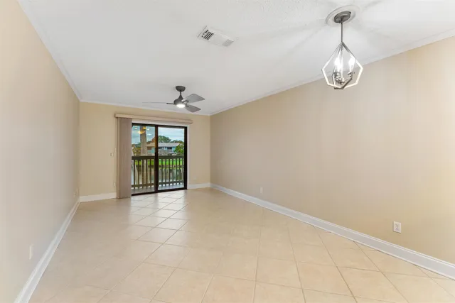 a view of an empty room with glass door