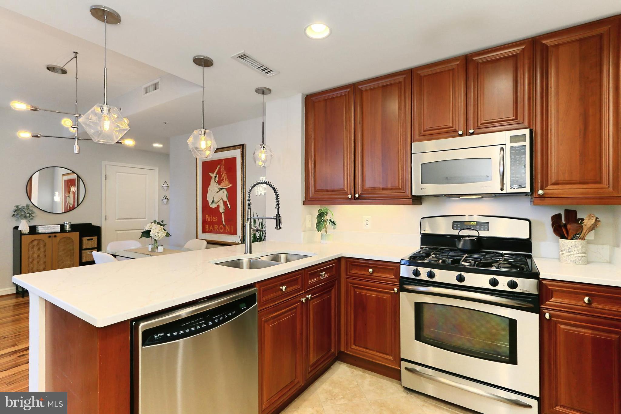 11990 Market Street, Unit 908 Reston, VA 20190 - Photo 9 of 45 a kitchen with a sink stove and microwave