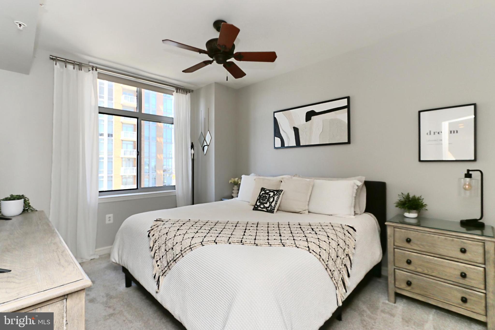11990 Market Street, Unit 908 Reston, VA 20190 - Photo 11 of 45 a bedroom with a large bed and a window