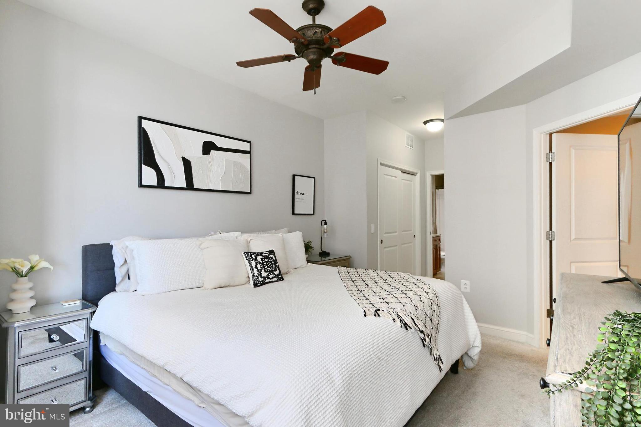 11990 Market Street, Unit 908 Reston, VA 20190 - Photo 12 of 45 a bedroom with a bed and a painting on the wall