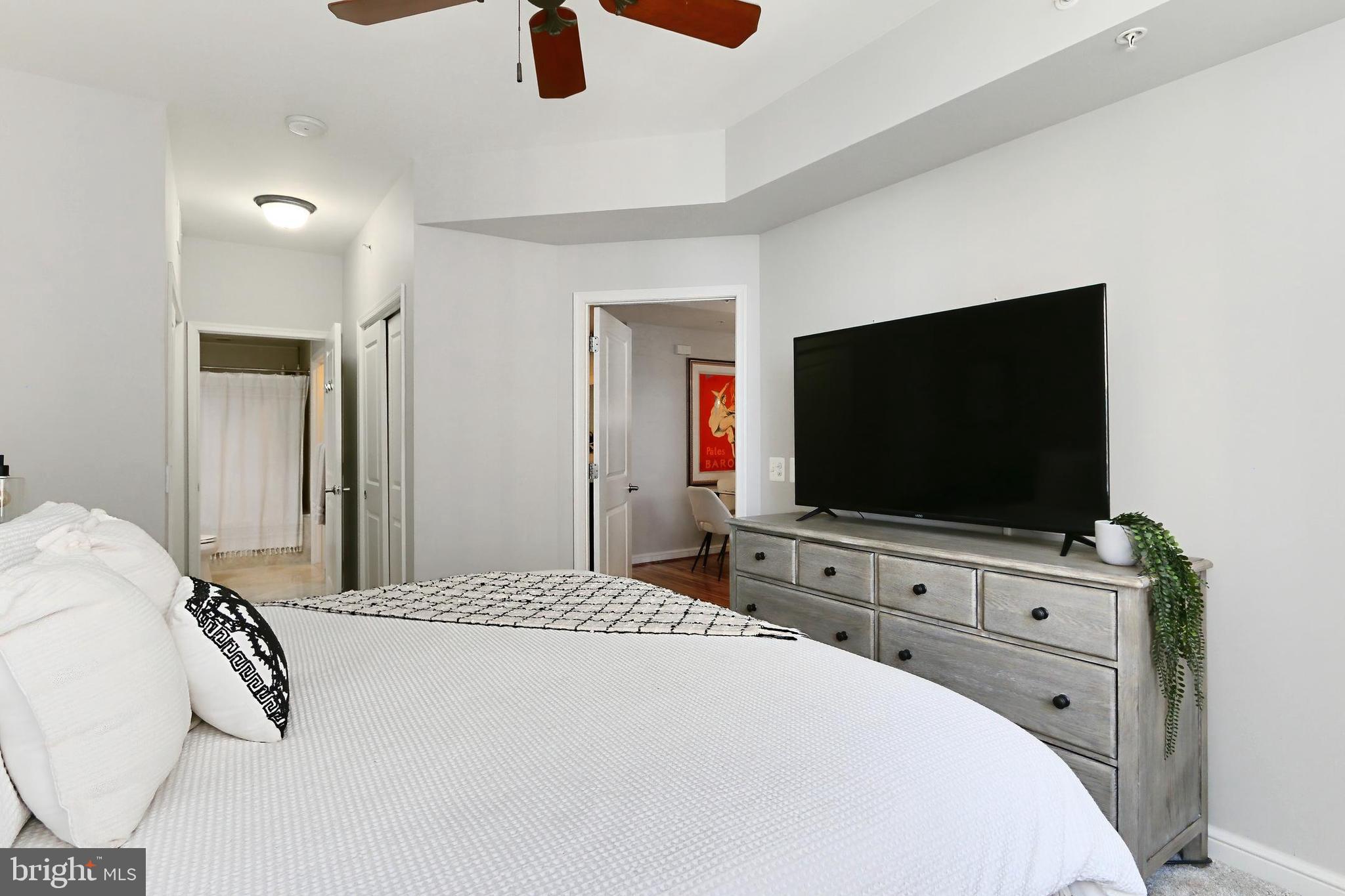 11990 Market Street, Unit 908 Reston, VA 20190 - Photo 13 of 45 a bedroom with a bed and a flat screen tv