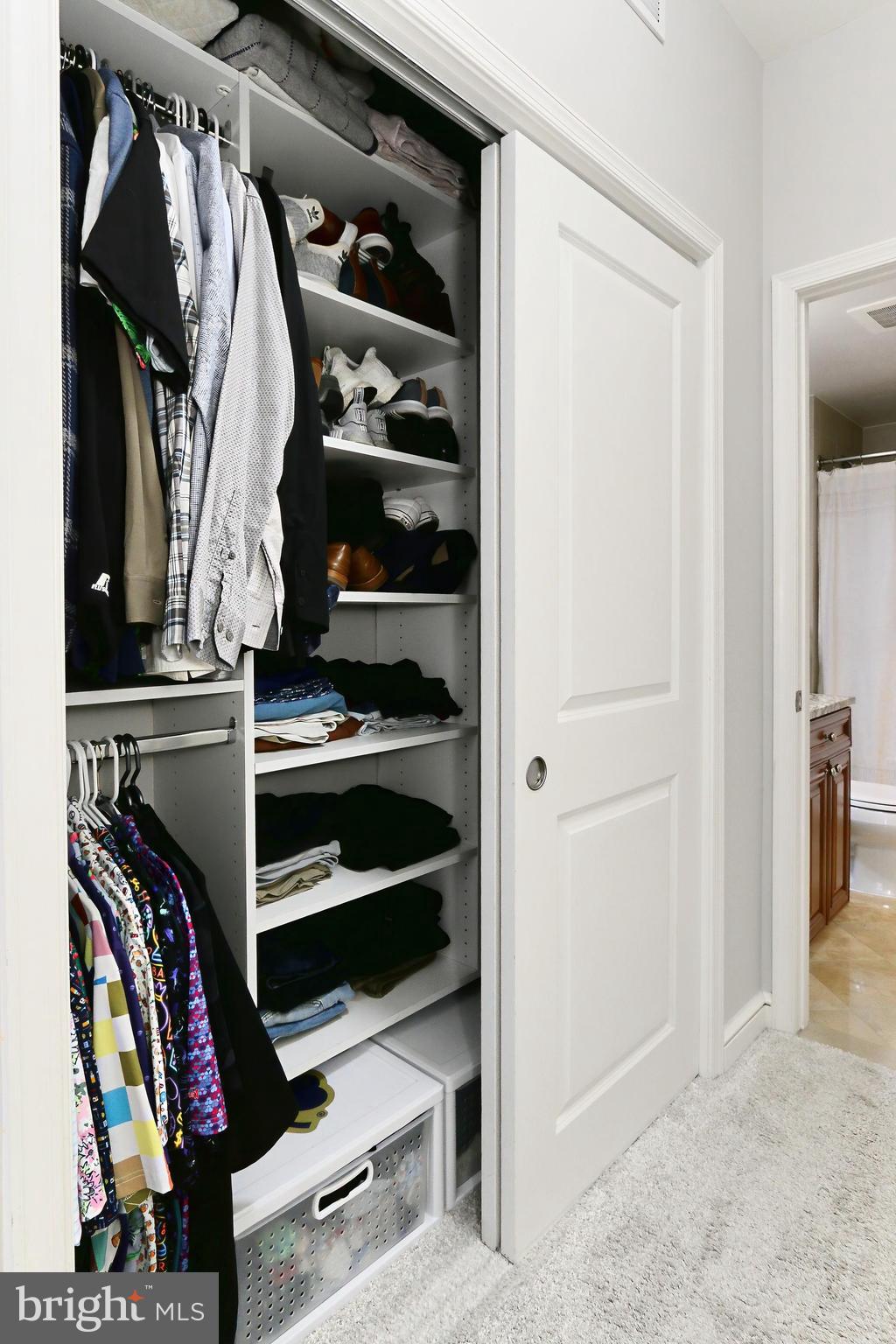 11990 Market Street, Unit 908 Reston, VA 20190 - Photo 16 of 45 a view of walk in closet with clothes and shoes