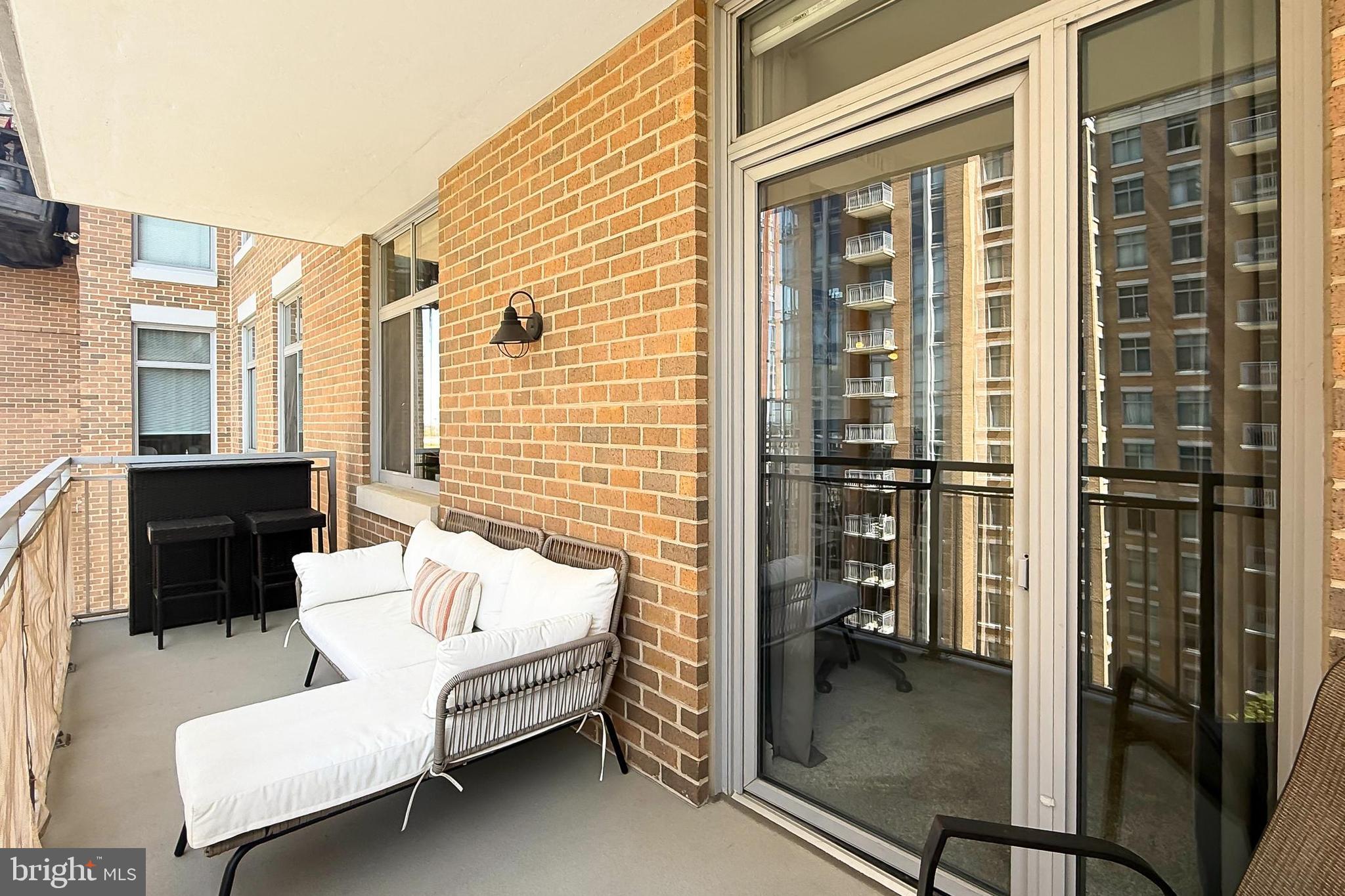 11990 Market Street, Unit 908 Reston, VA 20190 - Photo 20 of 45 a balcony with furniture and a gate