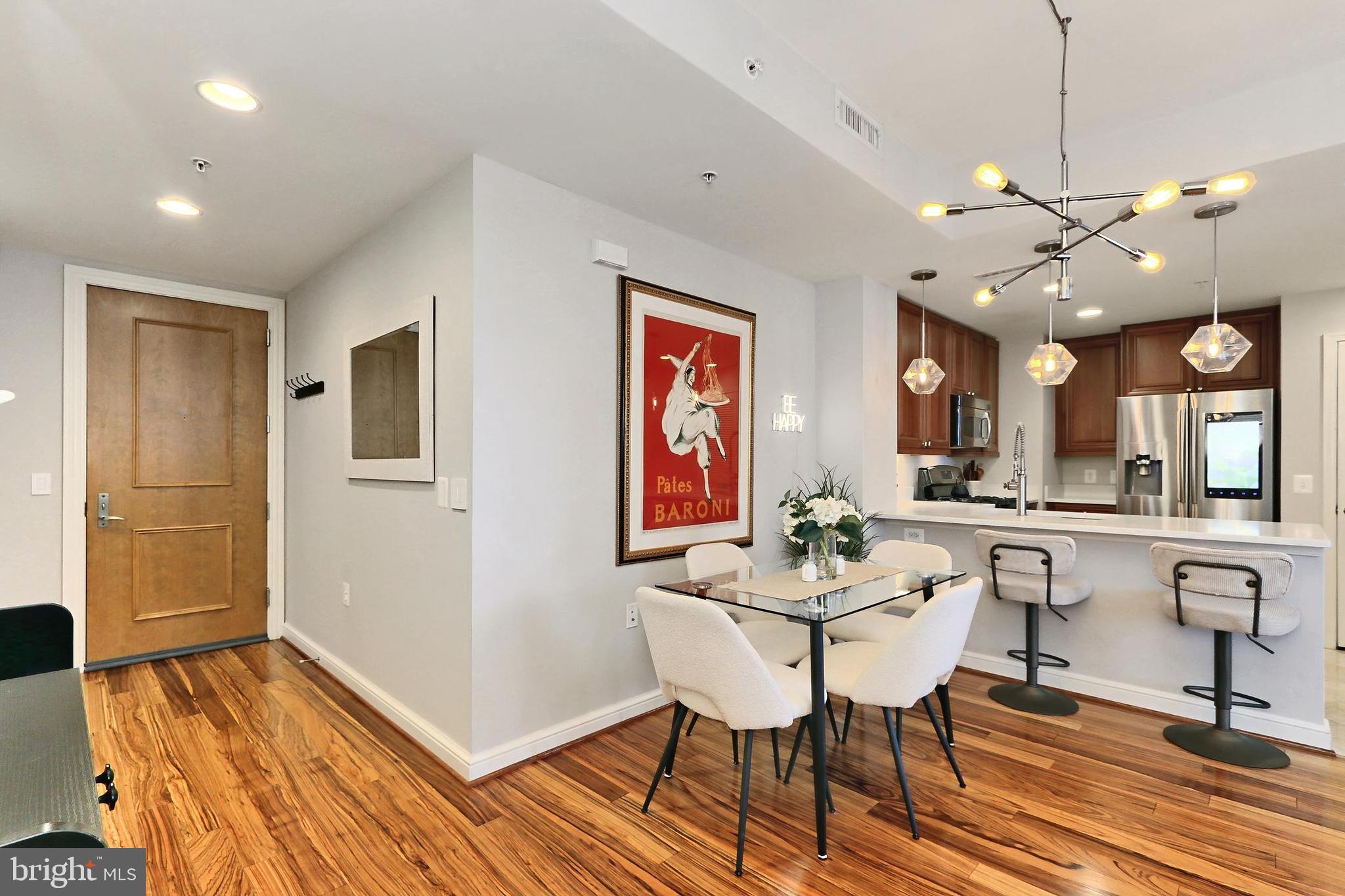 11990 Market Street, Unit 908 Reston, VA 20190 - Photo 4 of 45 a view of a dining room with furniture window and wooden floor