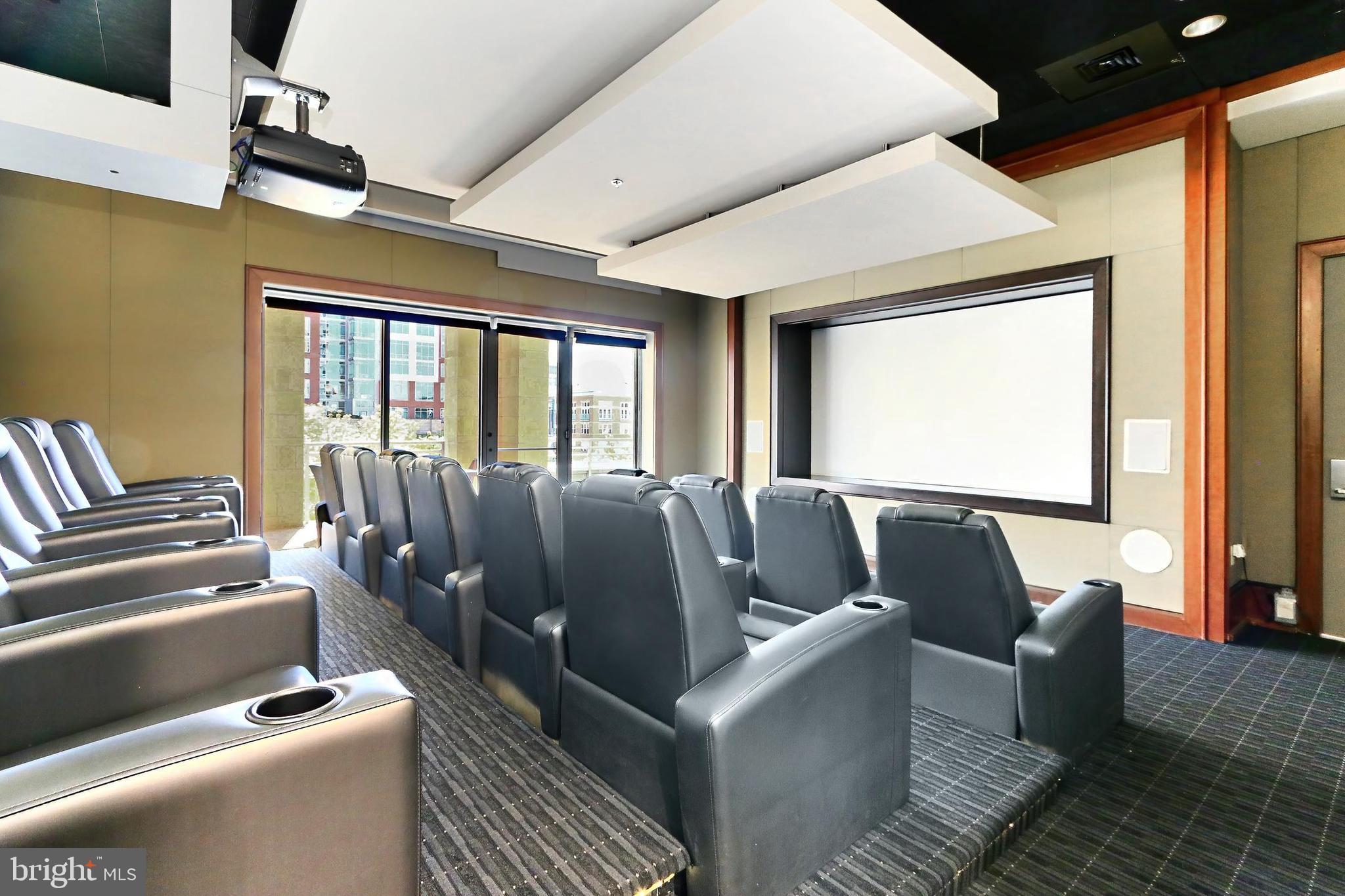 11990 Market Street, Unit 908 Reston, VA 20190 - Photo 37 of 45 a media room with lots of chairs and a projector screen