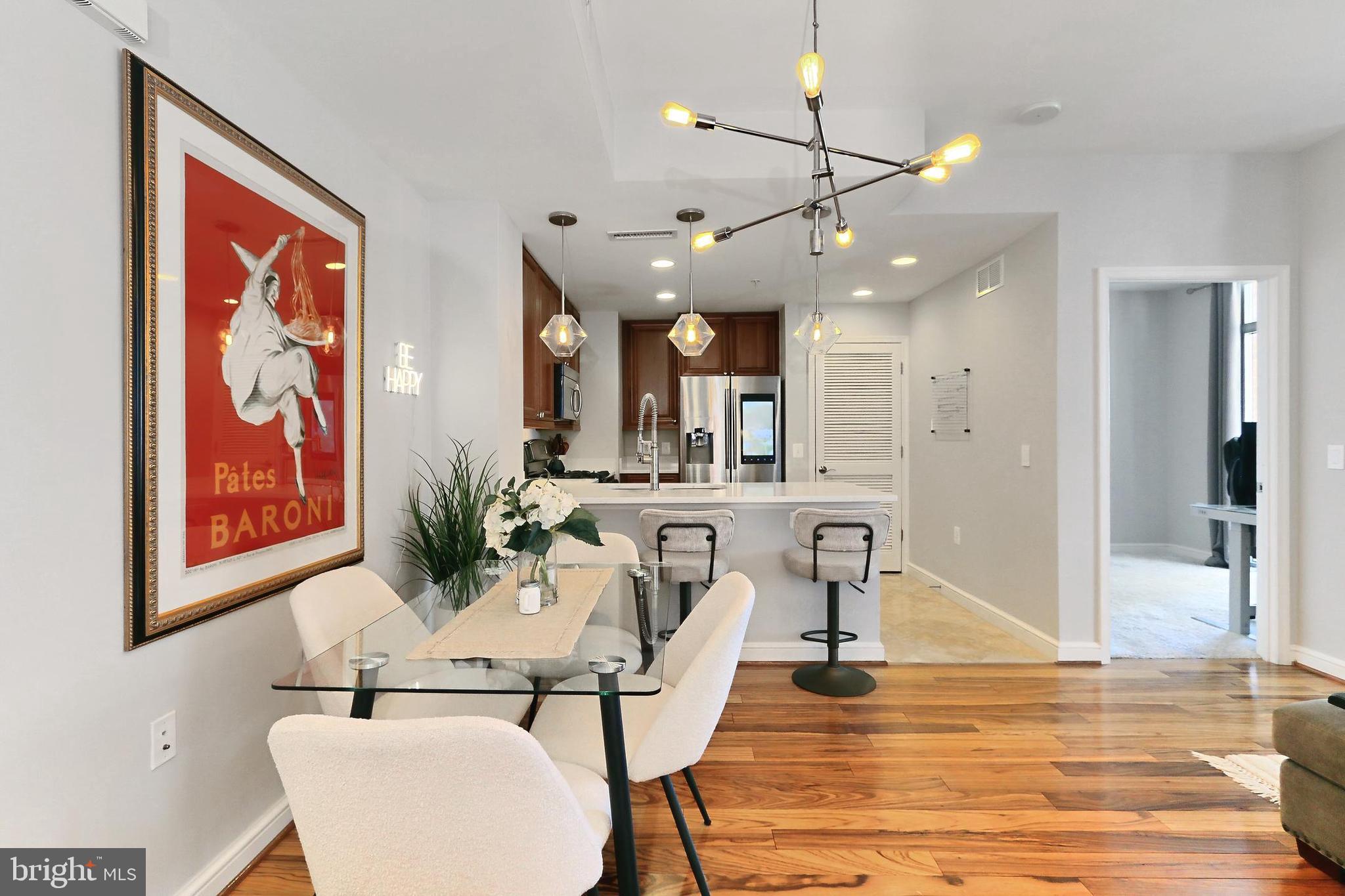 11990 Market Street, Unit 908 Reston, VA 20190 - Photo 5 of 45 a view of a dining room with furniture and wooden floor