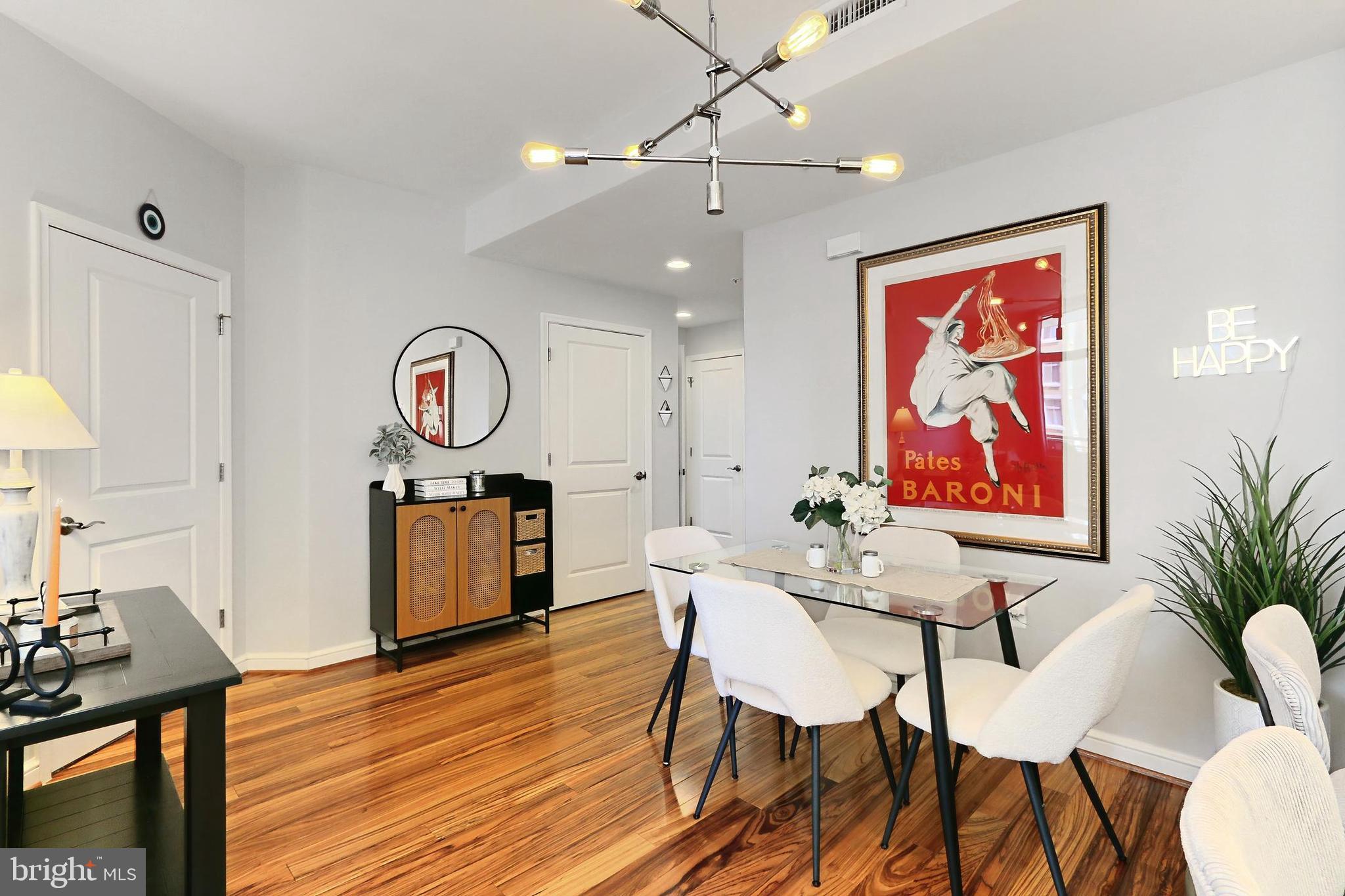 11990 Market Street, Unit 908 Reston, VA 20190 - Photo 6 of 45 a view of a dining room with furniture and wooden floor
