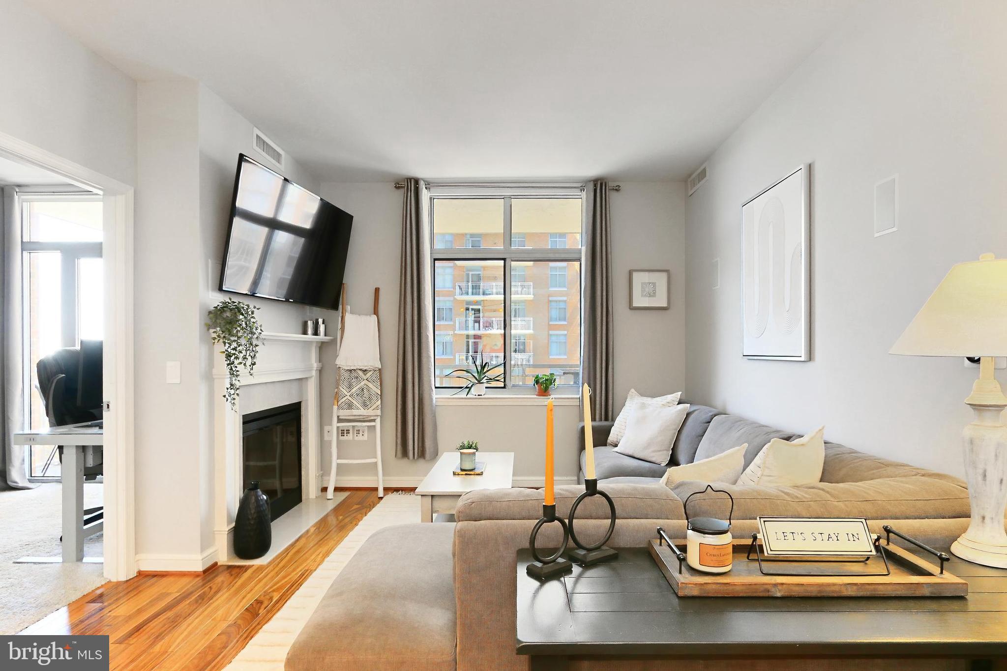 11990 Market Street, Unit 908 Reston, VA 20190 - Photo 42 of 45 a living room with furniture fireplace and flat screen tv