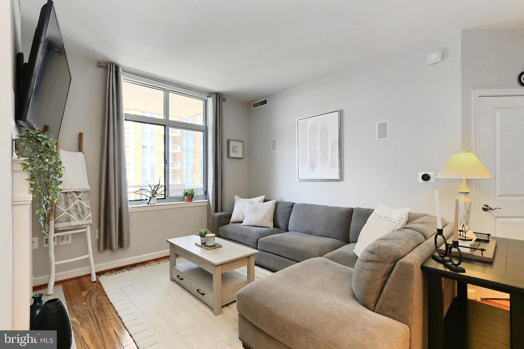 11990 Market Street, Unit 908 Reston, VA 20190 - Photo 43 of 45 a living room with furniture and a flat screen tv