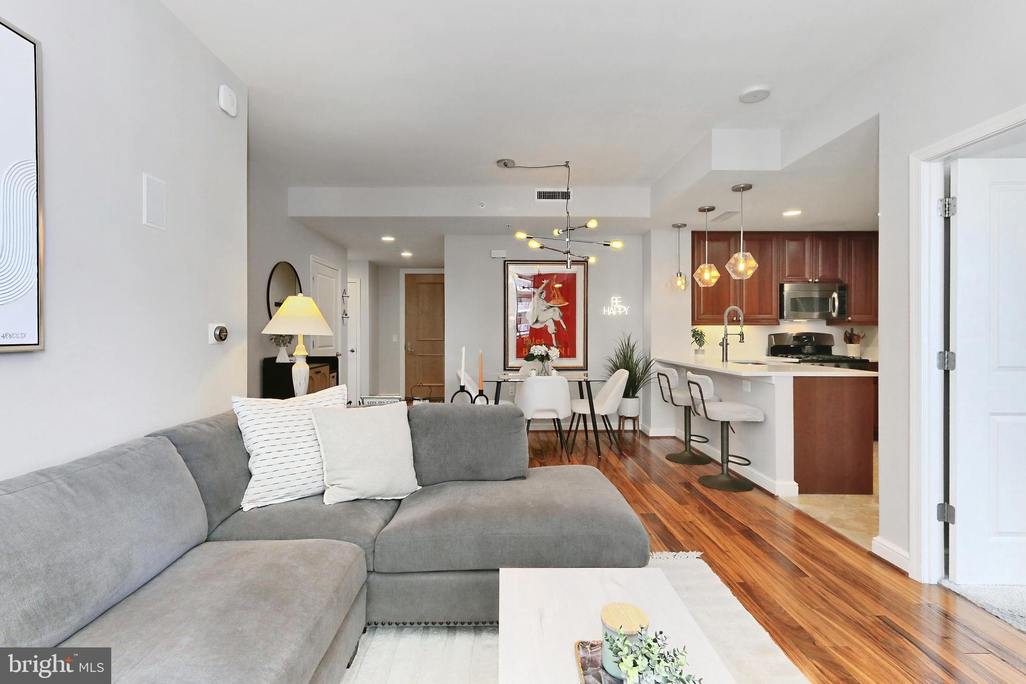 11990 Market Street, Unit 908 Reston, VA 20190 - Photo 44 of 45 a living room with furniture and kitchen view