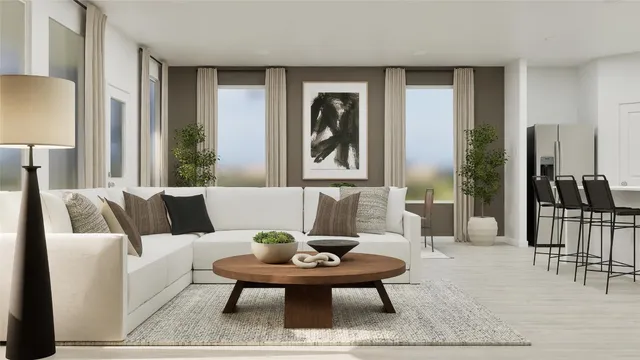 a living room with furniture and a potted plant