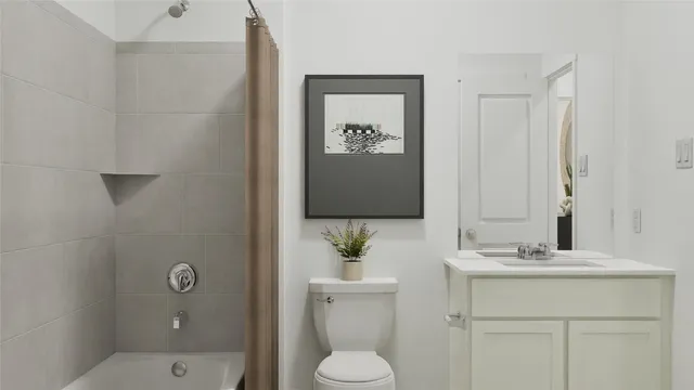 a bathroom with a sink vanity and toilet