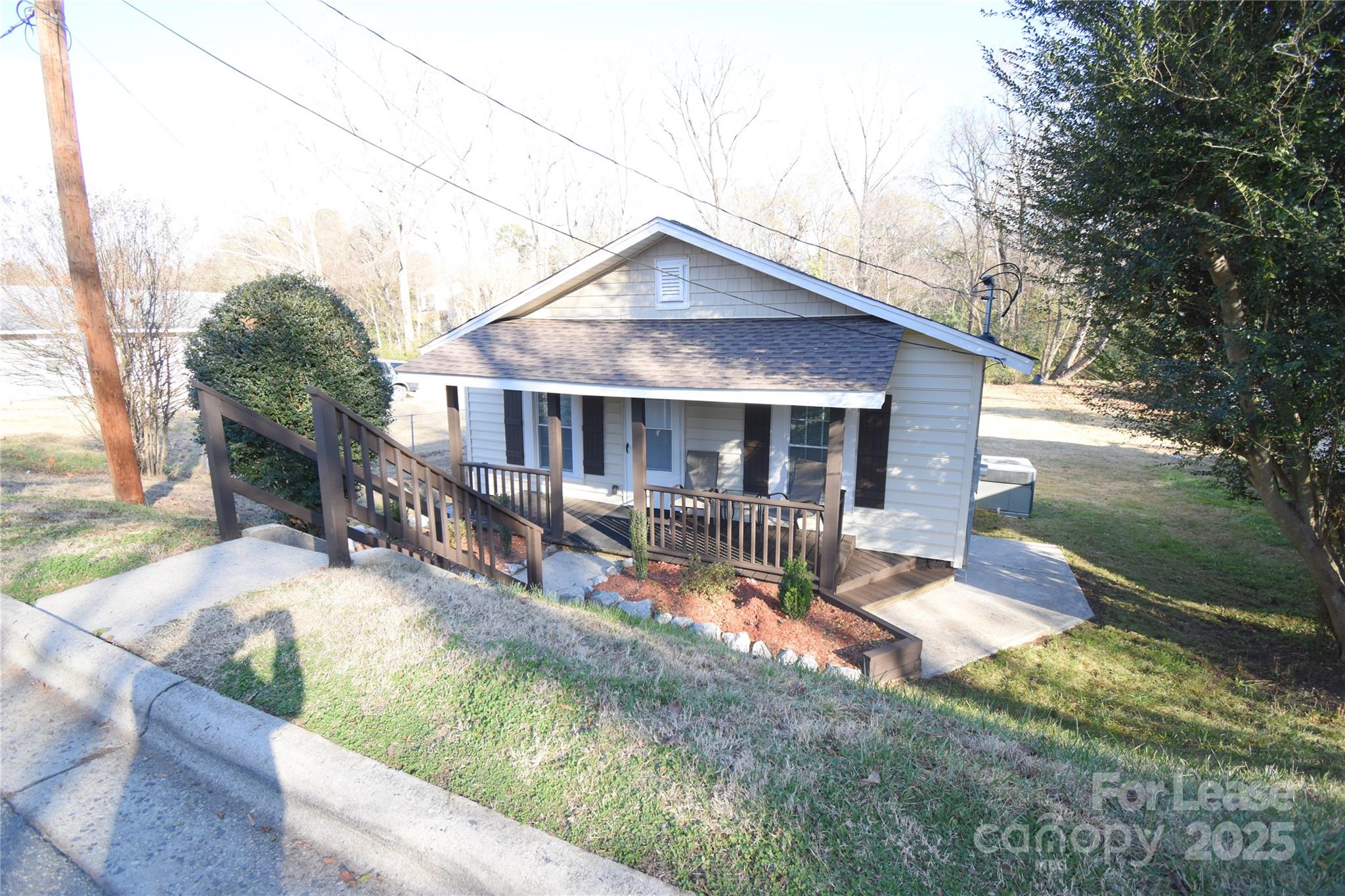 a view of house with yard and sitting area