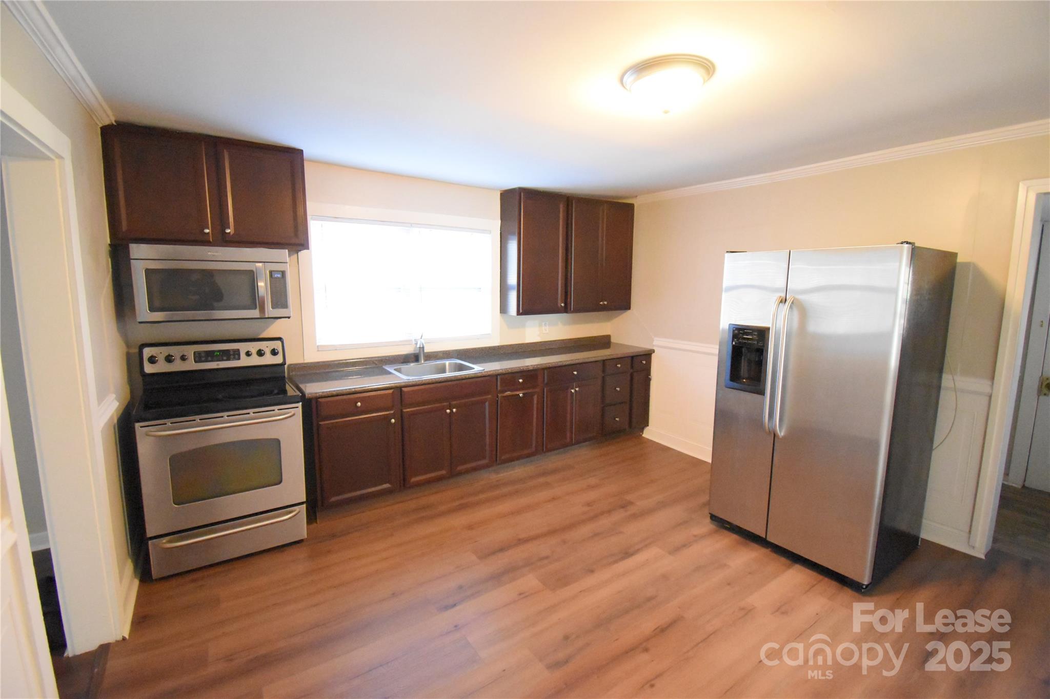337 Fox Street Southwest Concord, NC 28025 - Photo 5 of 16 a kitchen with granite countertop a refrigerator and a sink