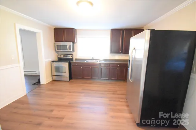 a kitchen with stainless steel appliances a refrigerator and a stove