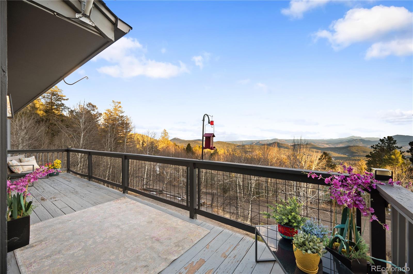 11740 Baca Road Conifer, CO 80433 - Photo 25 of 49 a view of a balcony with wooden floor
