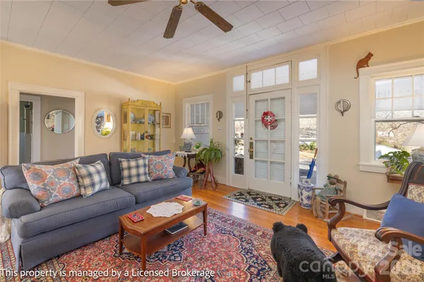 a living room with furniture and wooden floor