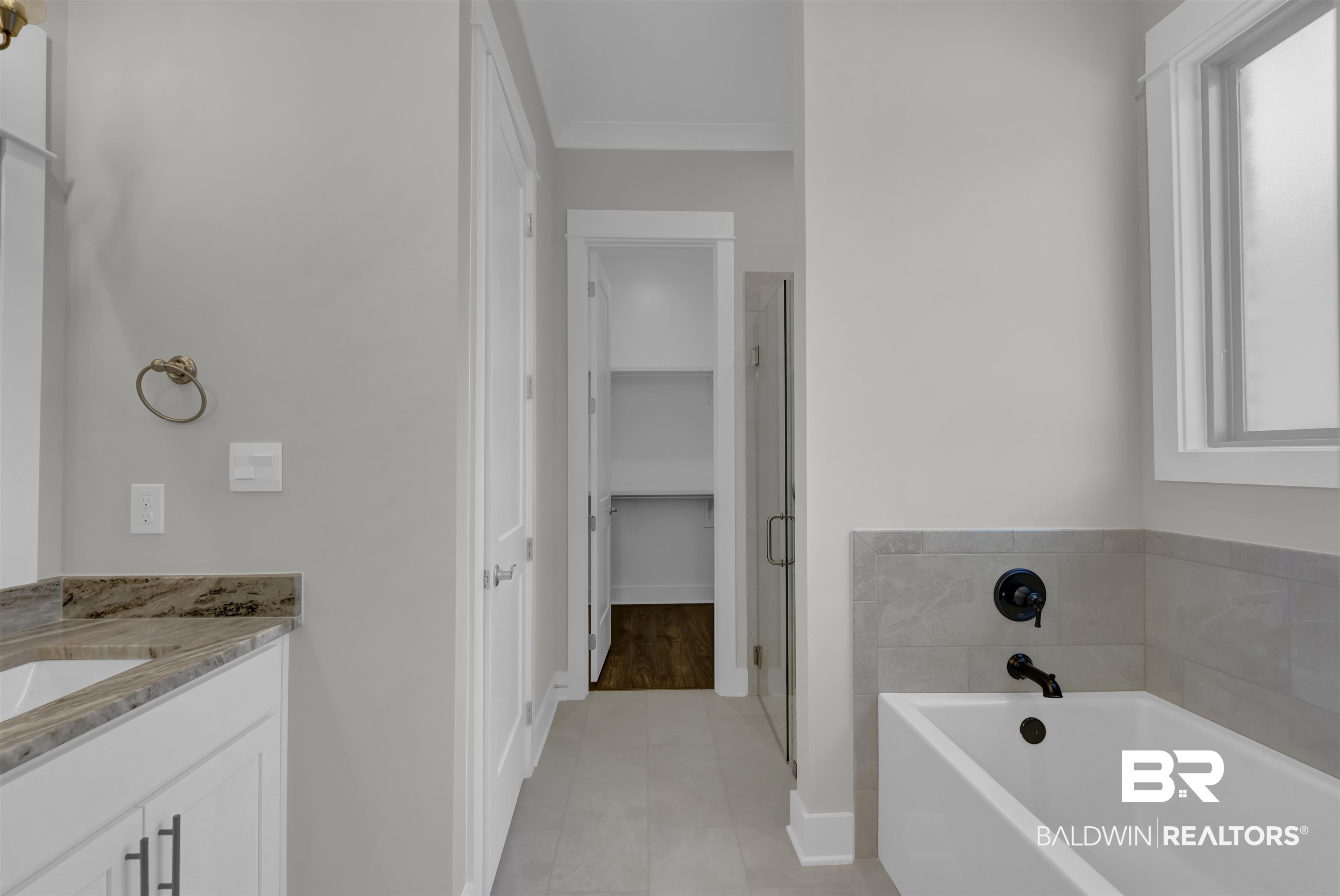 571 Morning Mist Way Fairhope, AL 36532 - Photo 25 of 47 Bathroom featuring vanity, a bath, a walk in closet, a stall shower, and light tile patterned floors